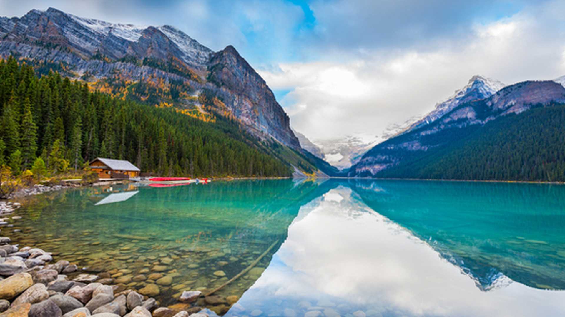 Lake Louise, backed by forests and mountains, in Banff National Park, Canada