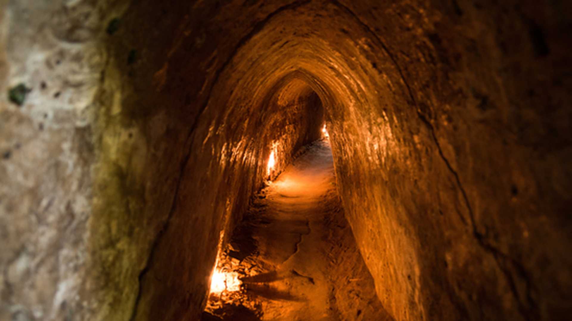 Crouching in the Cu Chi Tunnels near Ho Chi Minh City, Vietnam
