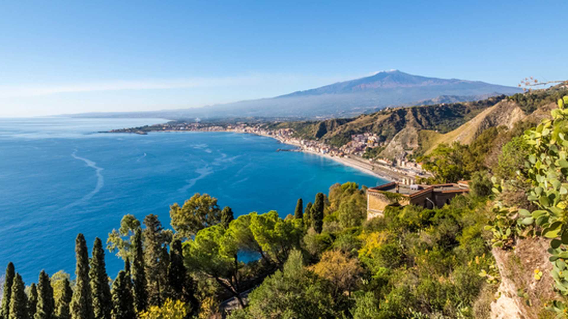 The bay of Giardini-Naxos with the Etna and Catania in the background viewed from Taormina, Sicily Italy. 