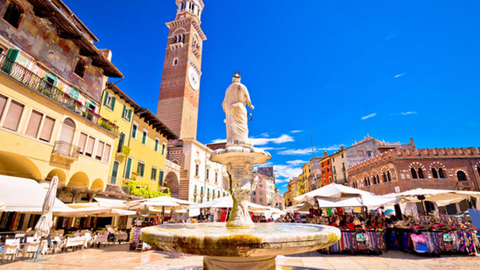 Piazza delle Erbe in Verona street and market view with Lamberti tower, Veneto region of Italy