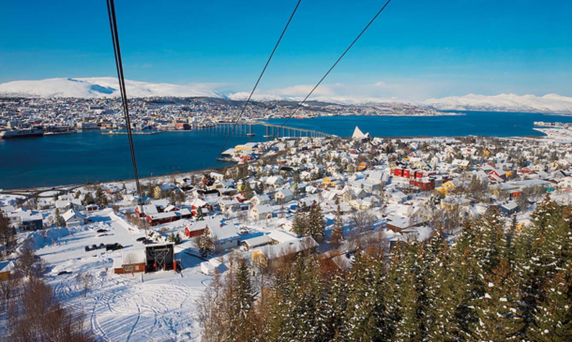 View to the Tromso city from the Fjellheisen aerial tramway cabin in Tromso, Norway.