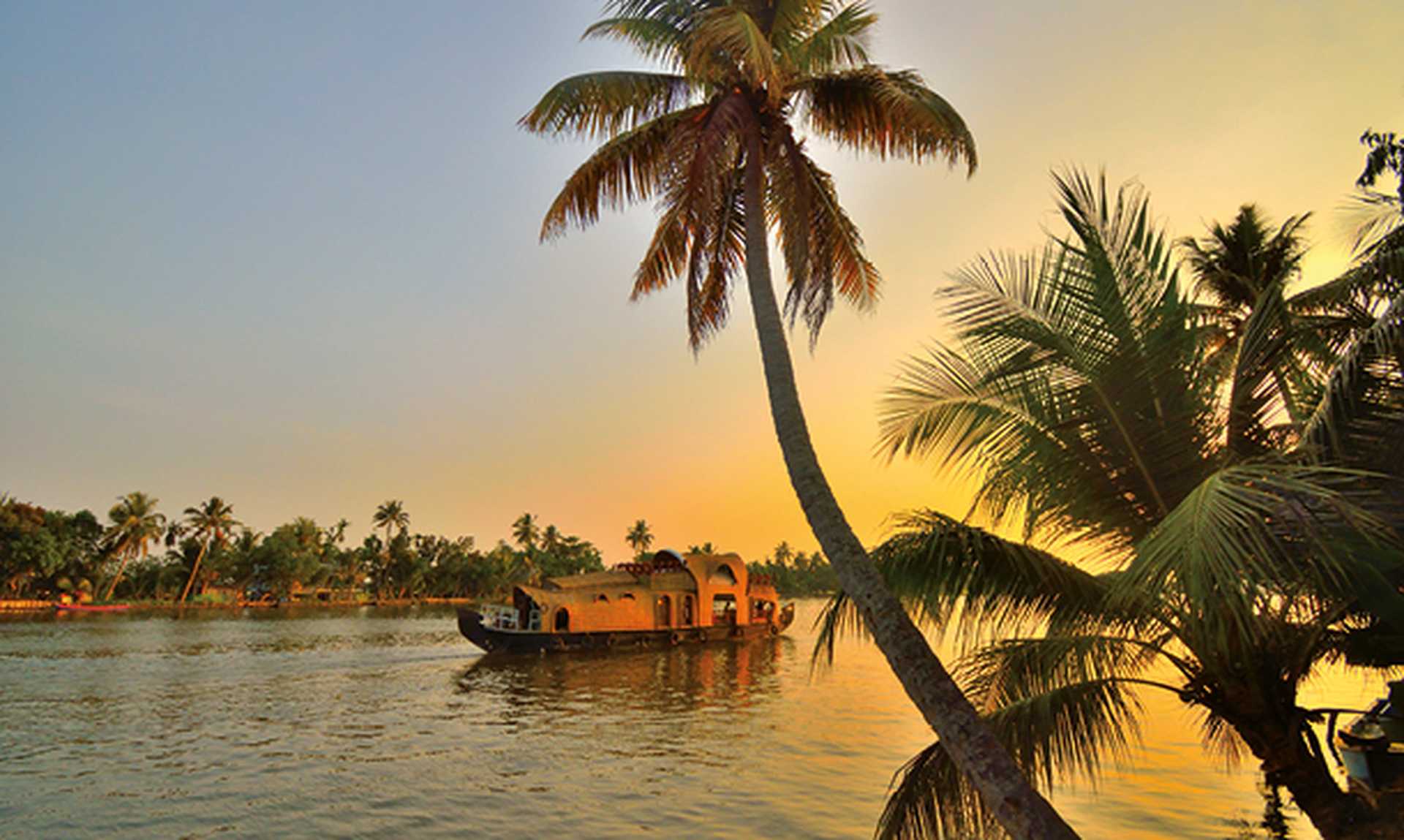 A houseboat sailing in kerala backwaters during sunset.