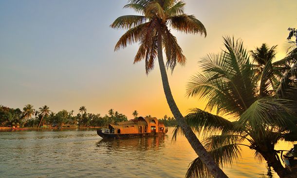 A houseboat sailing in kerala backwaters during sunset.