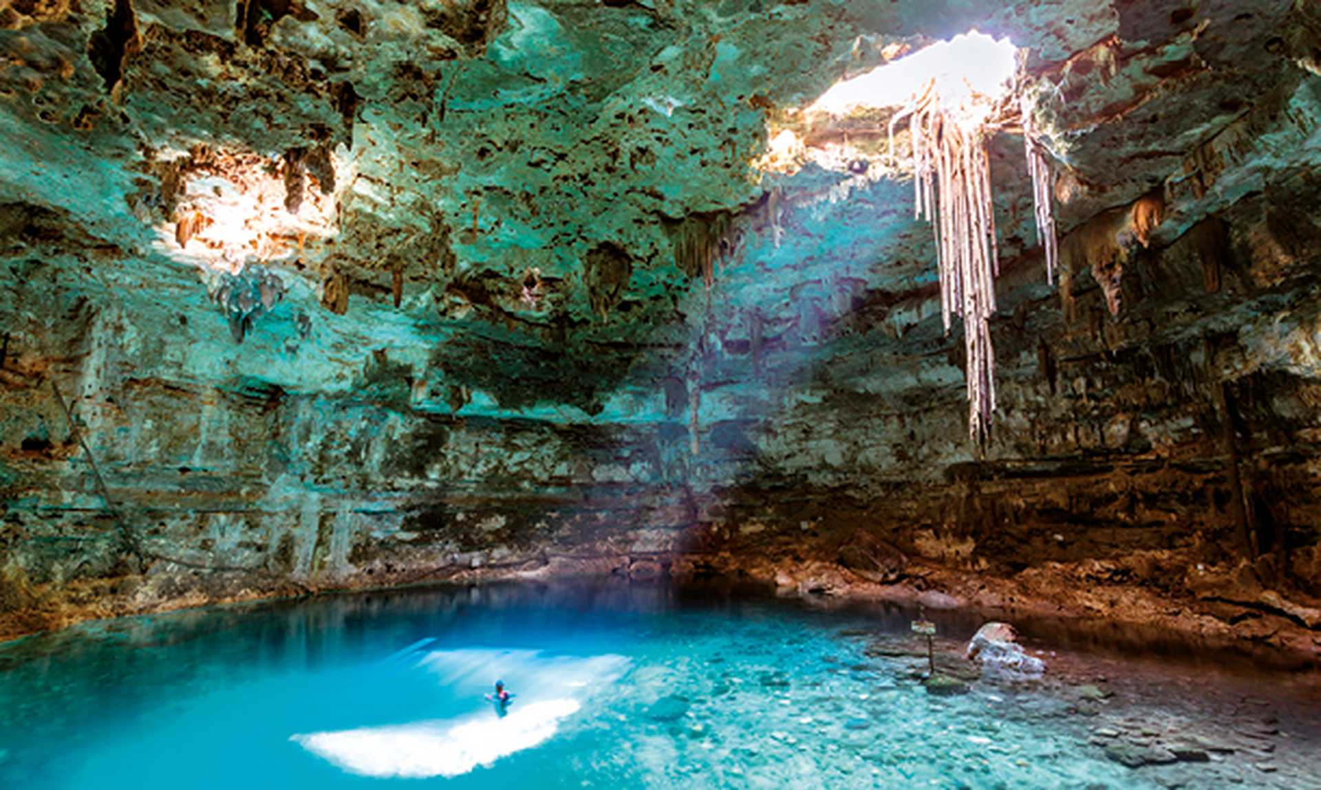Man swimming in a cenote, Yucatan, Mexico