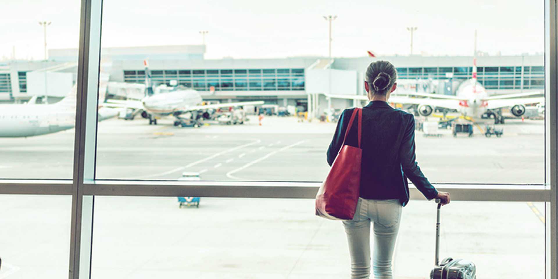 Travel tourist standing with luggage at airport lounge. 
