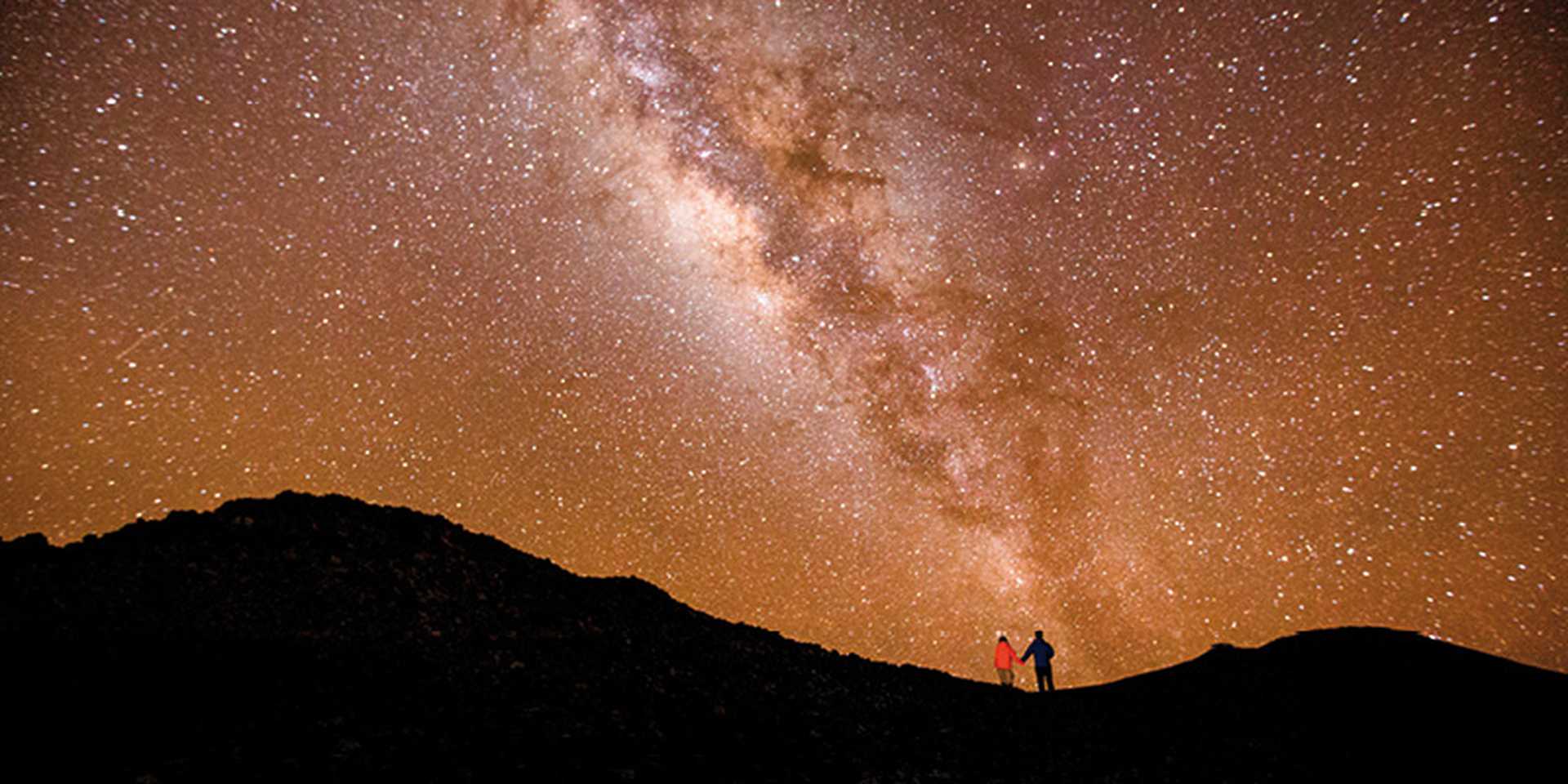 People star-gazing at night sky