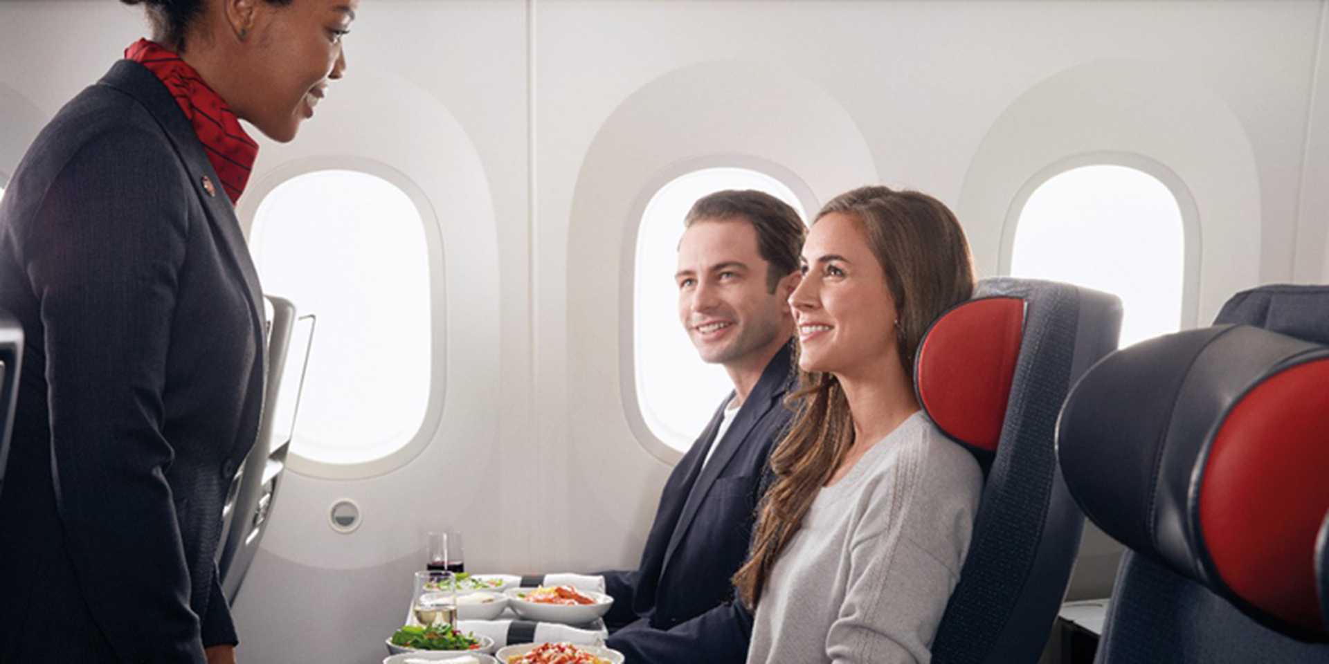 Air Canada - Premium economy, hostess serving couple