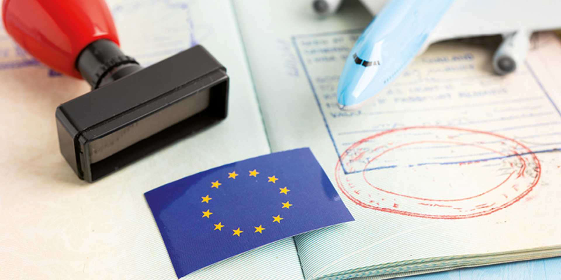 Eu flag with approved Stamp visa and passport document to immigration at airport in country.
