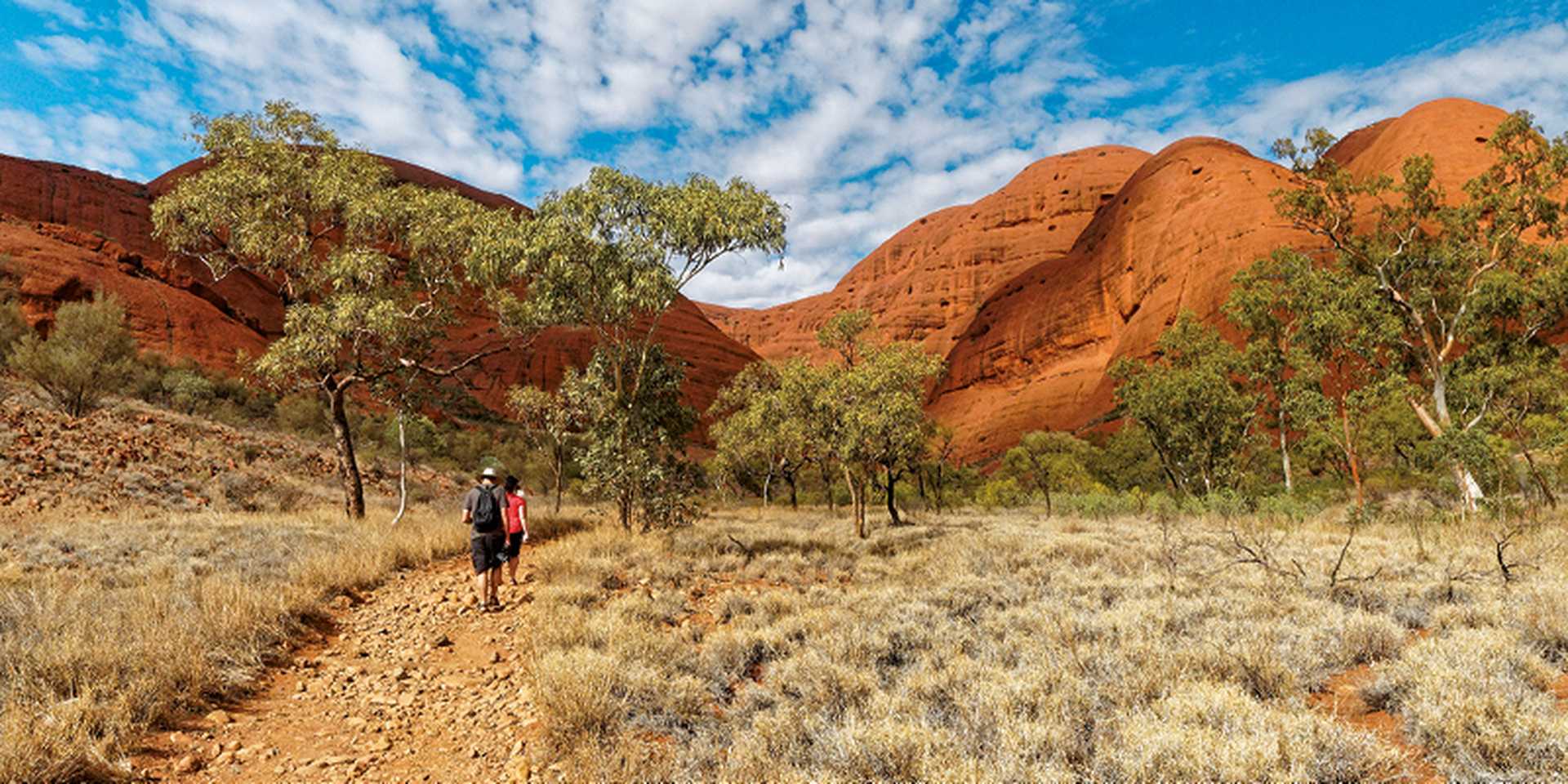 Walkers hiking through red rocks of Kata Tjuta, Northern Territory, Australia