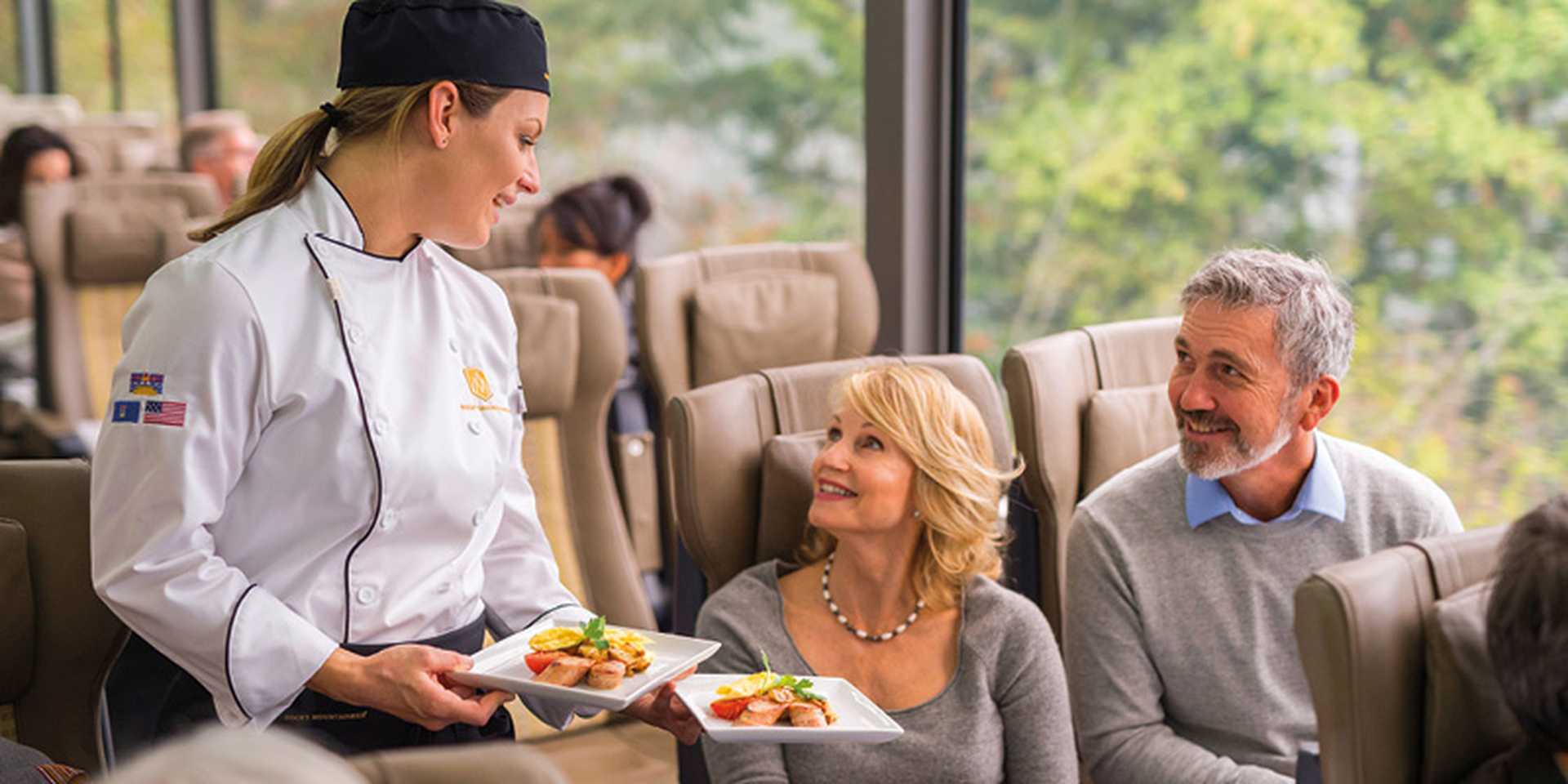 Couple being served food, SilverLeaf Service, Rocky Mountaineer