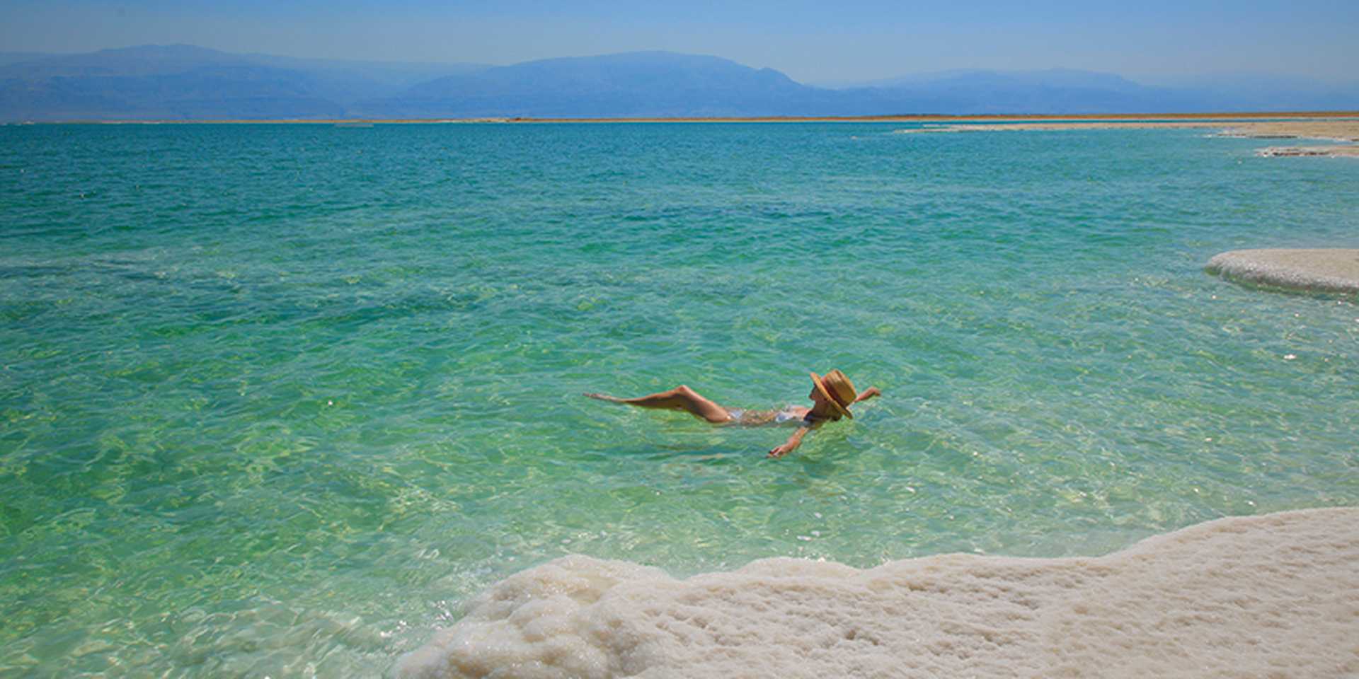 Girl relaxing in the water of Dead Sea