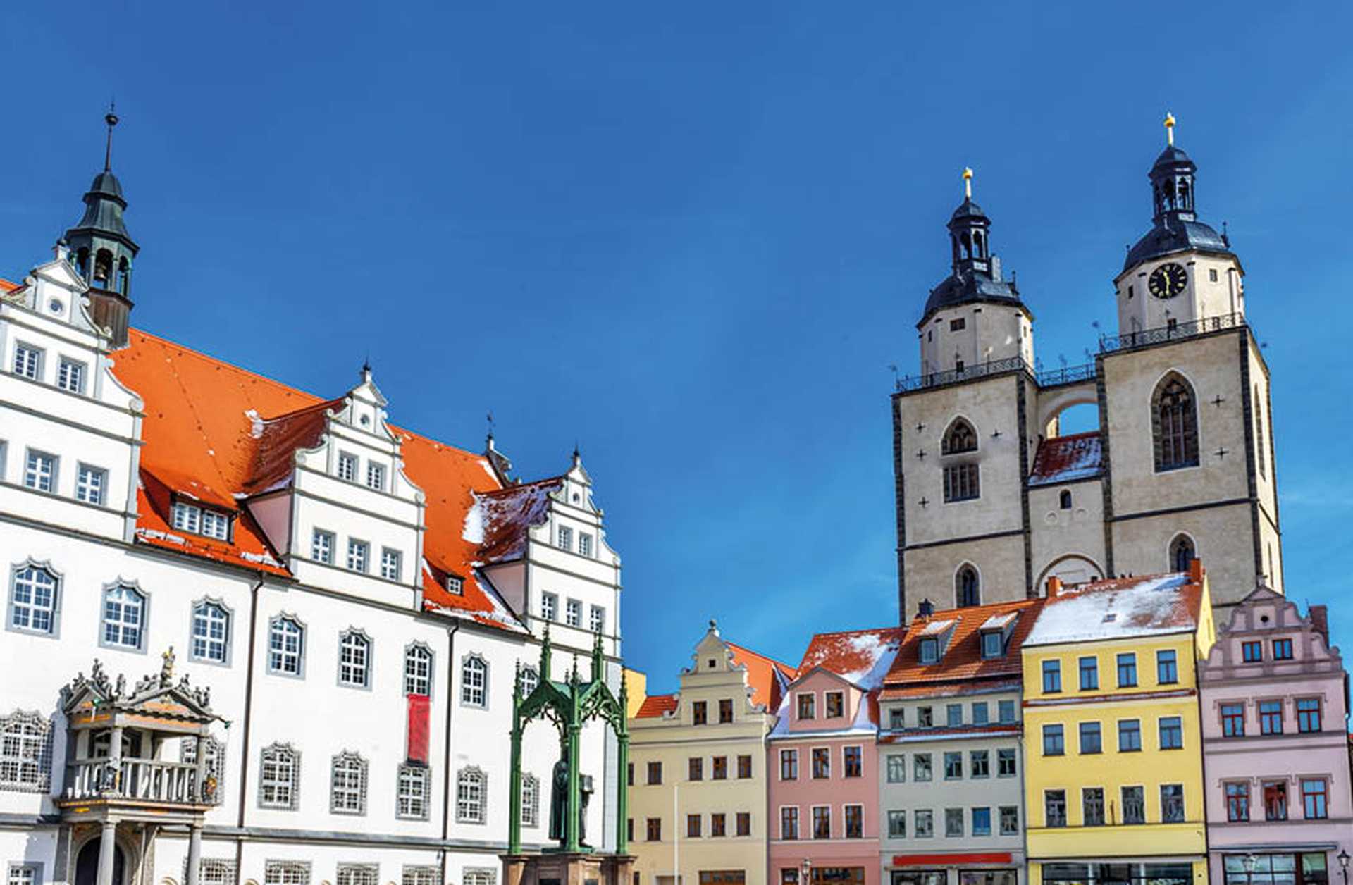 Colourful houses line the Market Square in Wittenberg, where a statue of Martin Luther stands