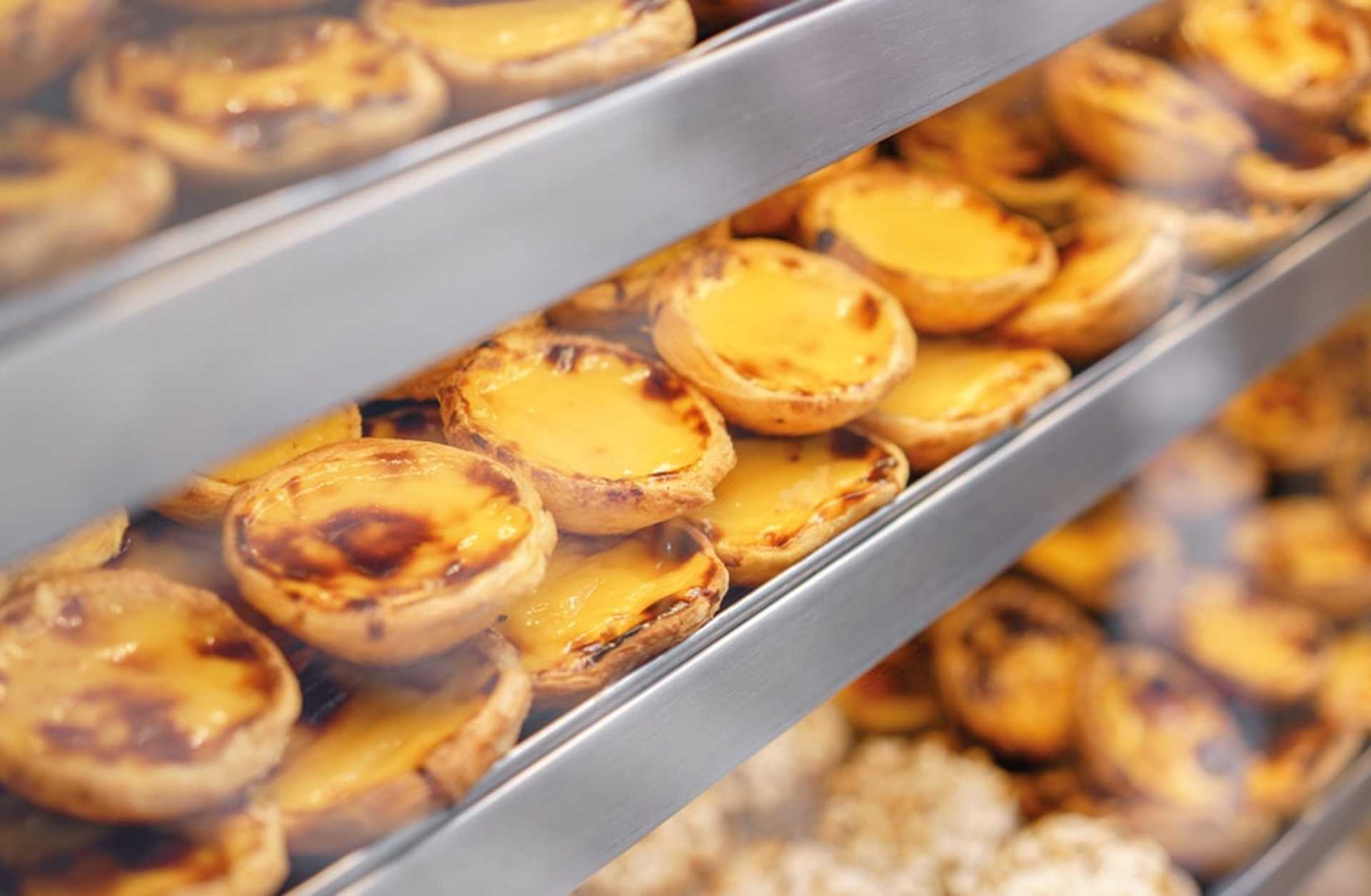Trays of pasteis de nata (custard tarts) in a bakery