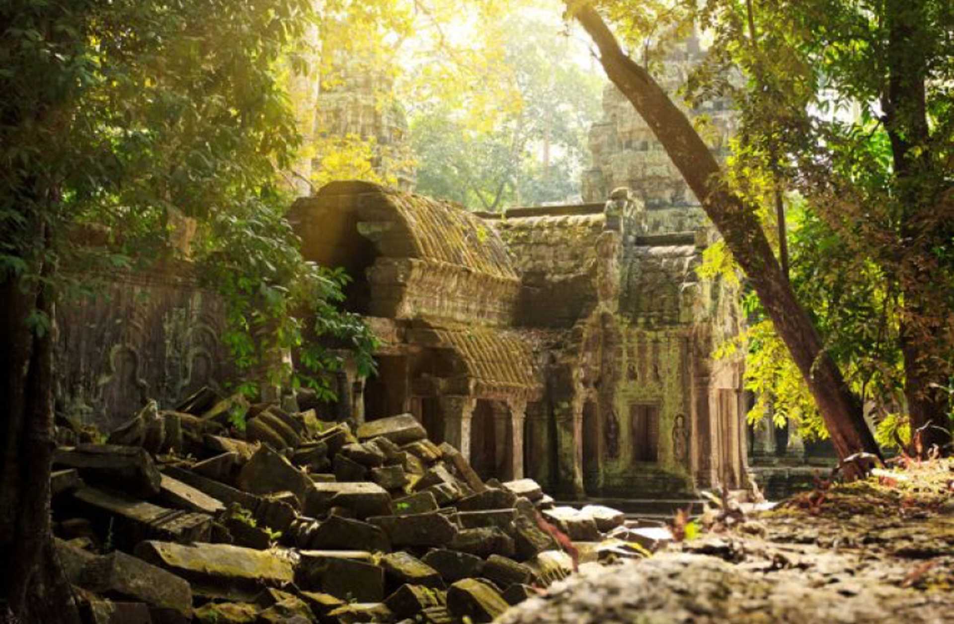 Crumbling temples surrounded by greenery at Angkor in Cambodia