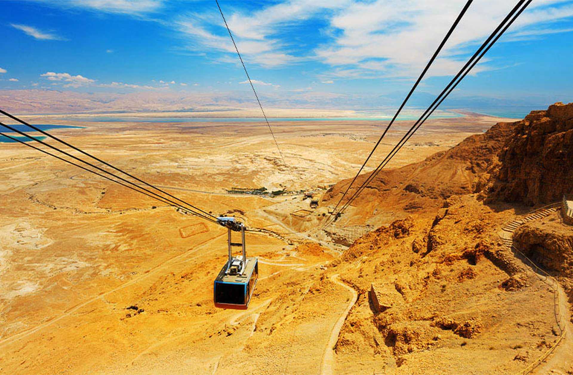 A cable car travels up to the ancient fortress of Masada in Israel, looking down on the Dead Sea and desert