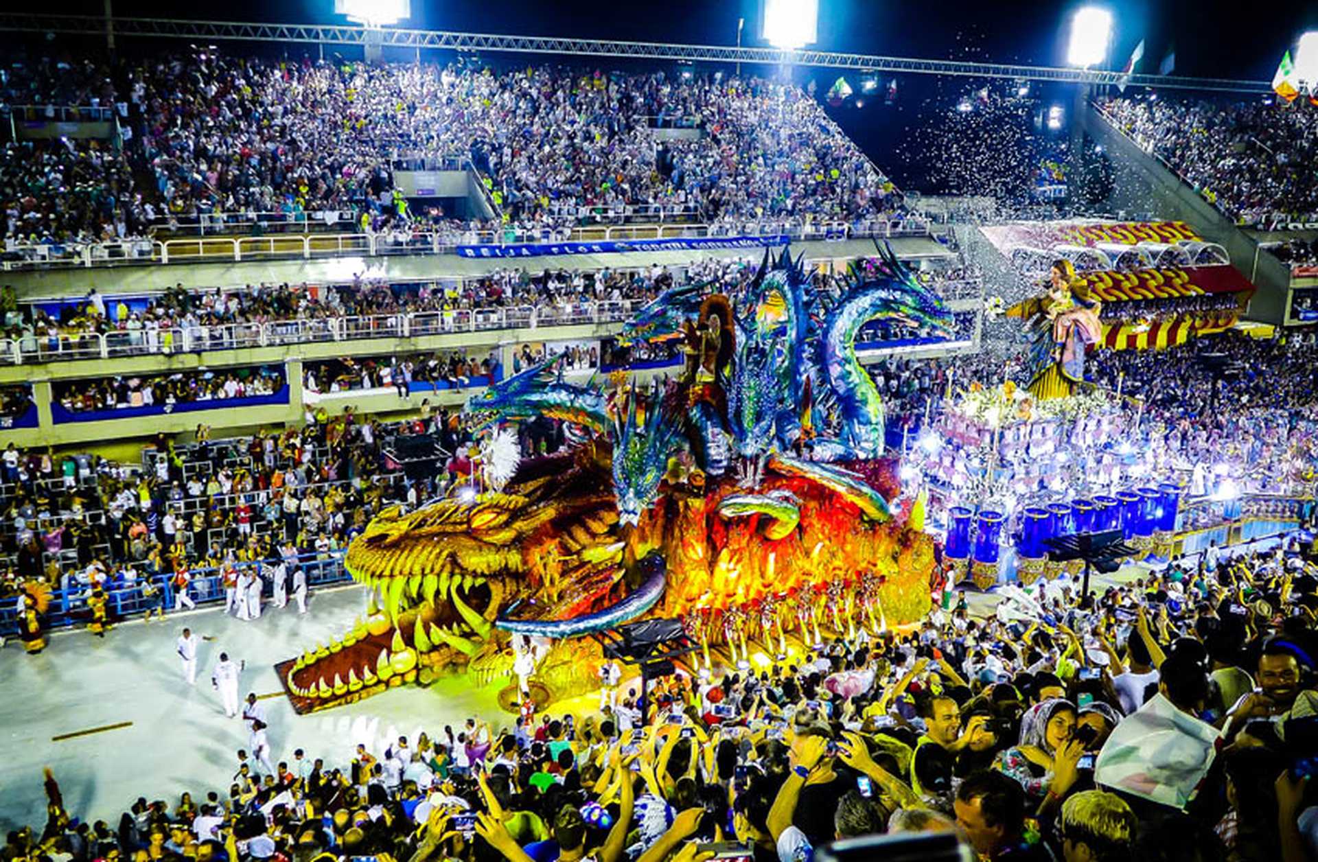 A colourful float passes through the Rio Carnival, with crowds on either side