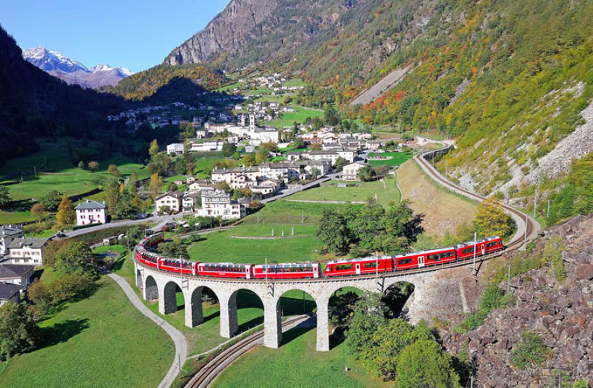 The Bernina Express crosses the famous Brusio spiral viaduct of Rhaetian Railway in Brusio,  Switzerland