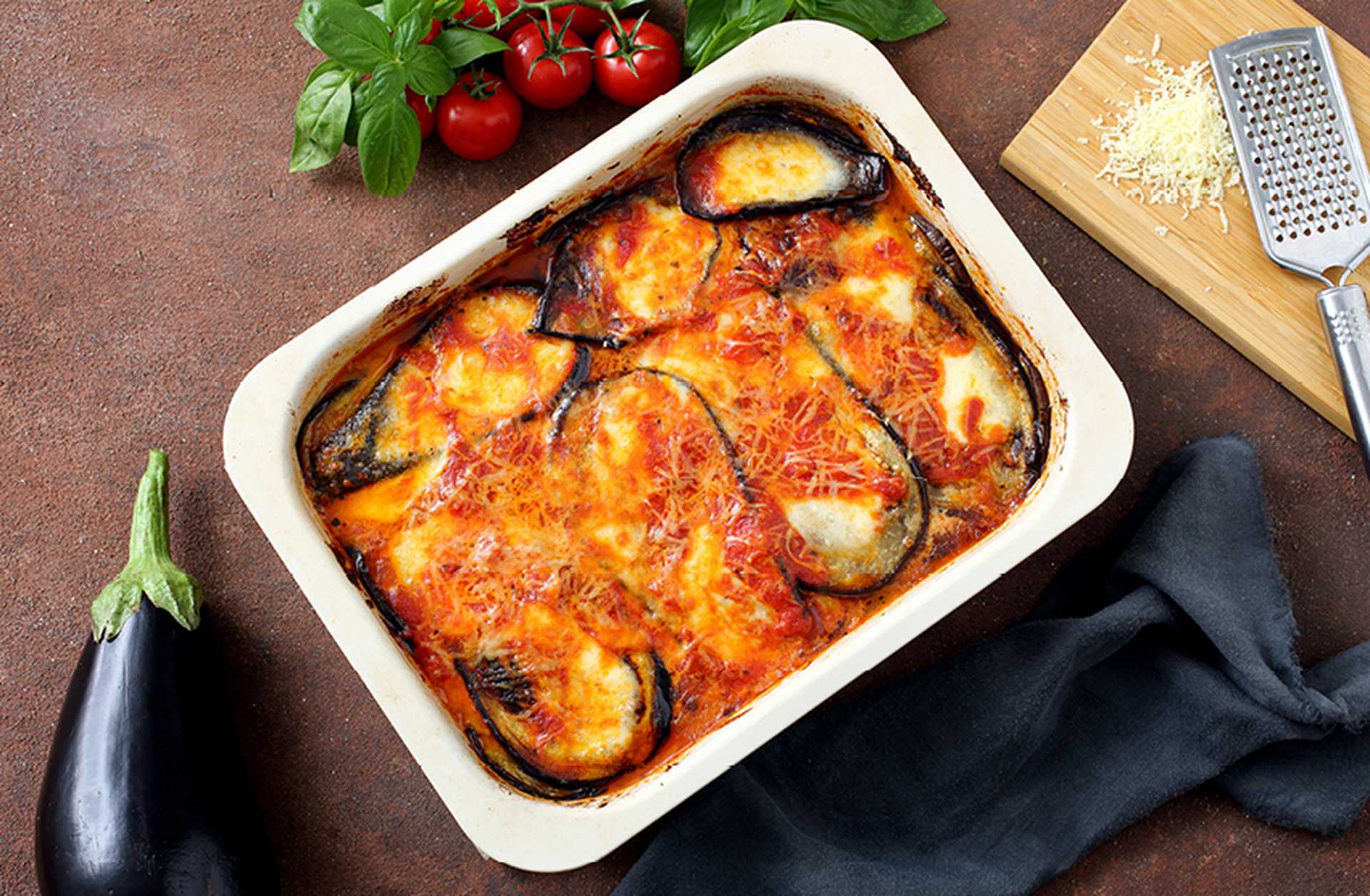 Aubergine parmigiana is served in a white dish