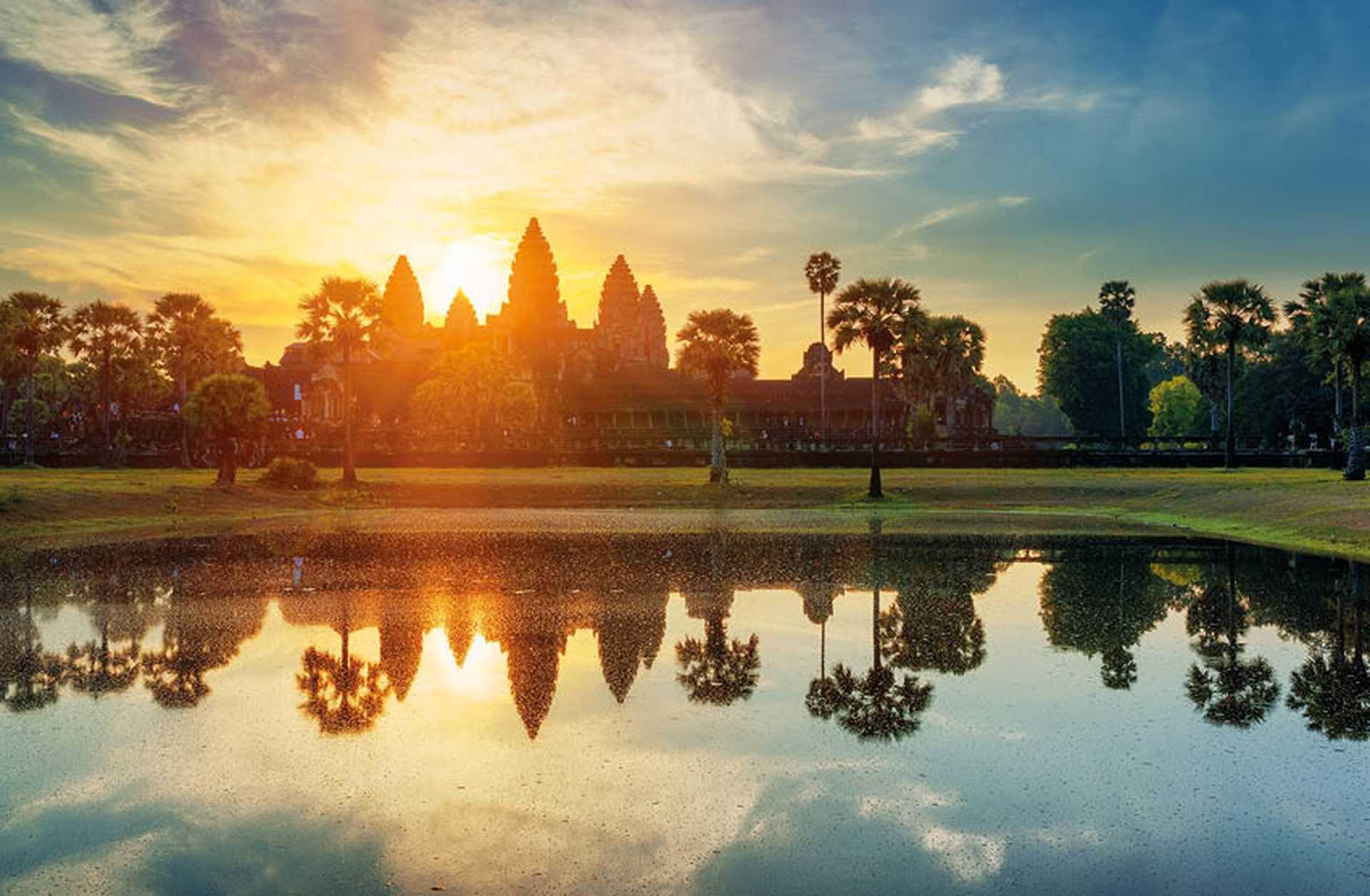 The sun rises behind Angkor Wat temple in Cambodia