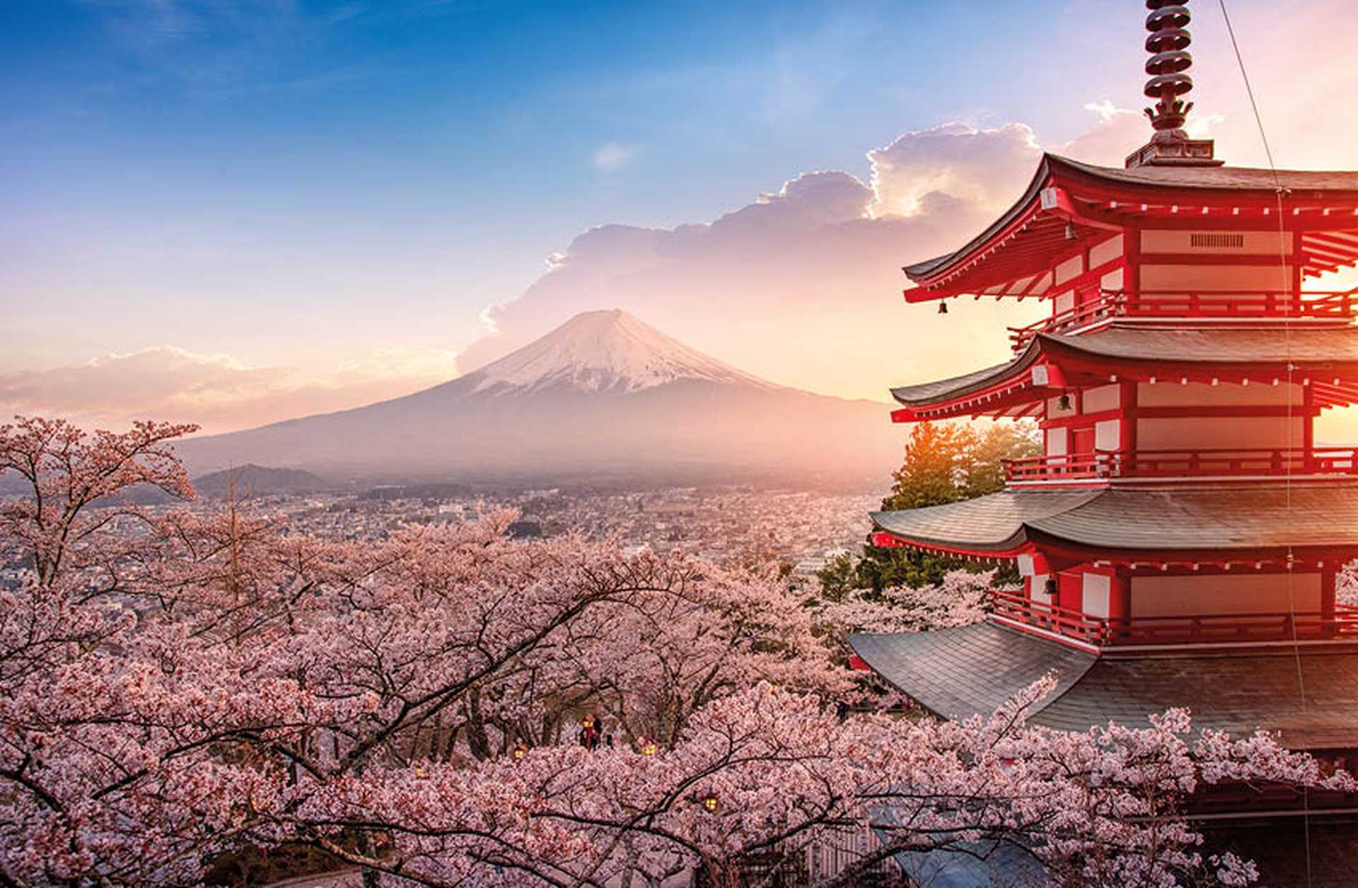 Chureito Pagoda in Japan, surrounded by cherry blossom trees with Mount Fuji in the background