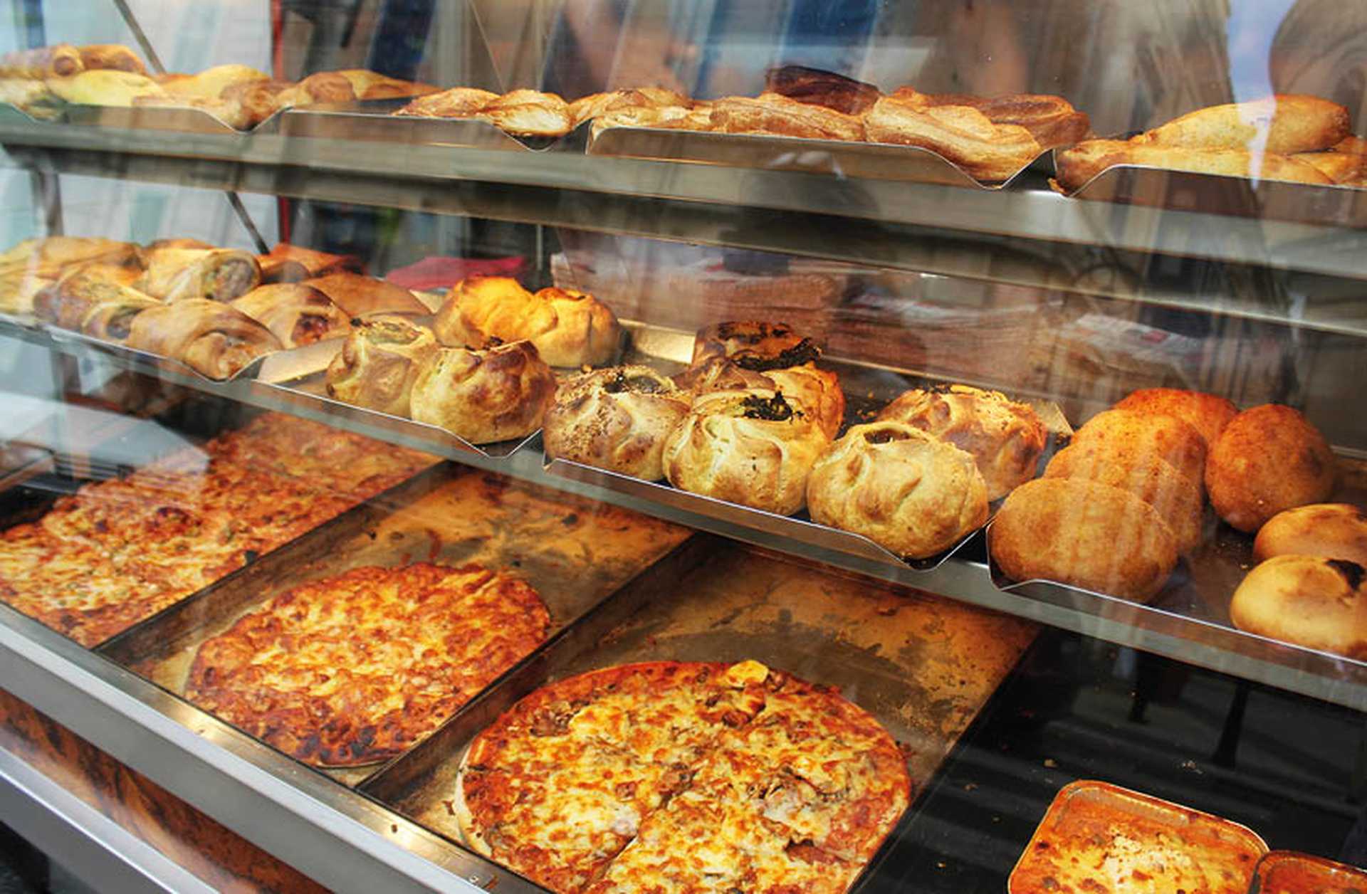 Pizza and pastizzi (pastries) for sale in a bakery in Malta