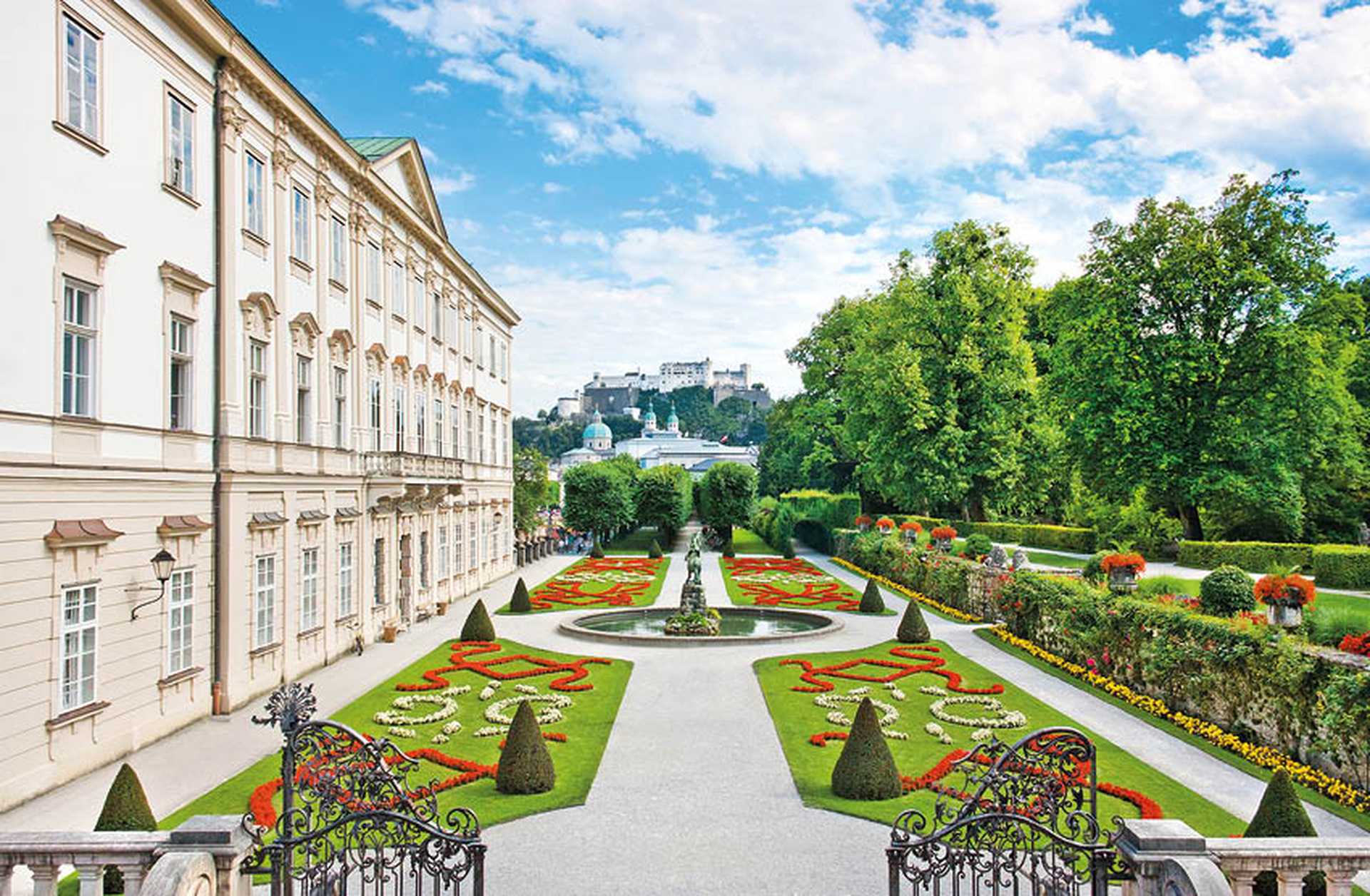 Mirabell Gardens with Mirabell Palace and the old historic Fortress Hohensalzburg in the background in Salzburg, Austria