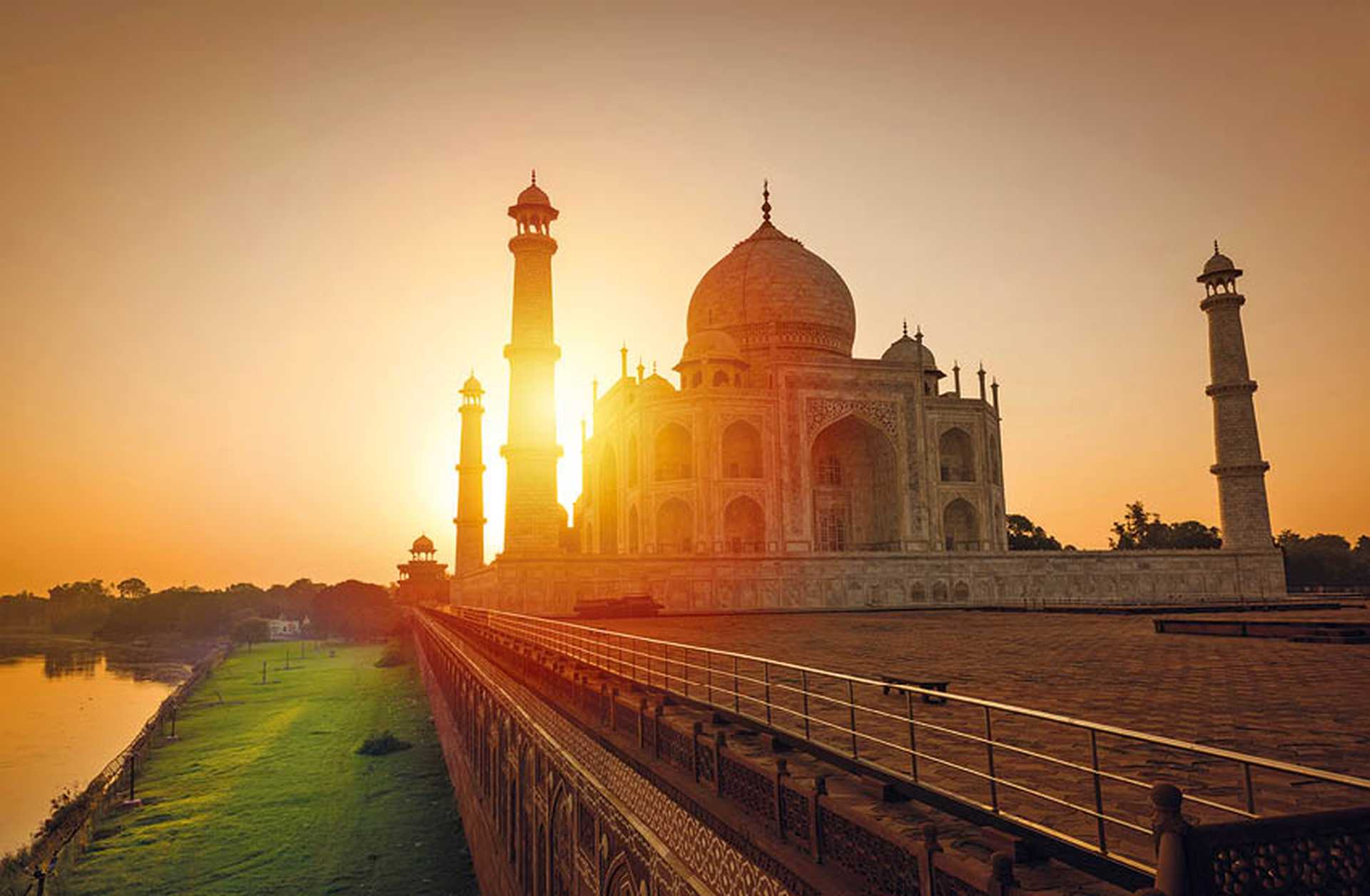 The sun rises behind the Taj Mahal in India