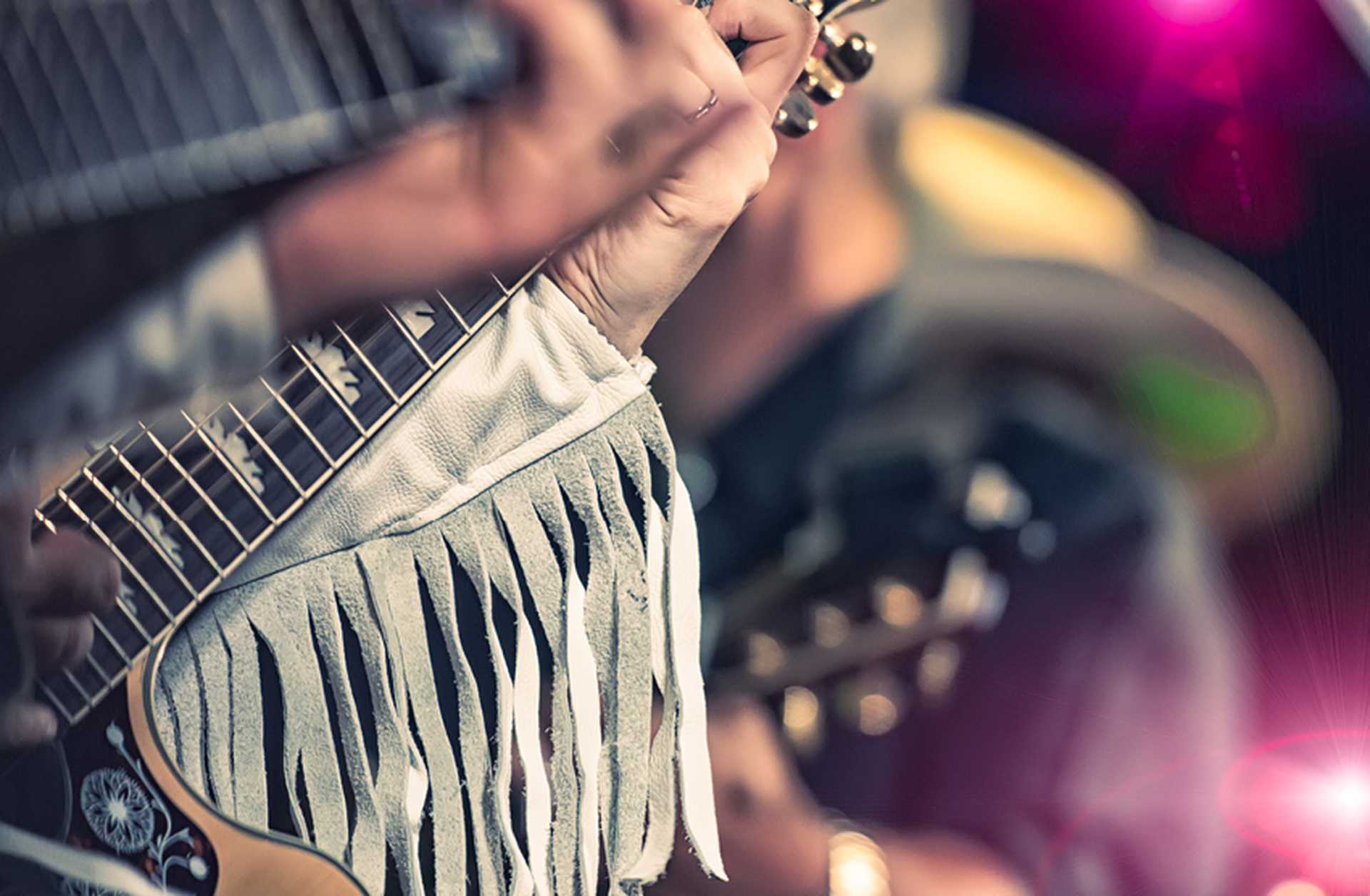 Close-up of hands playing a guitar