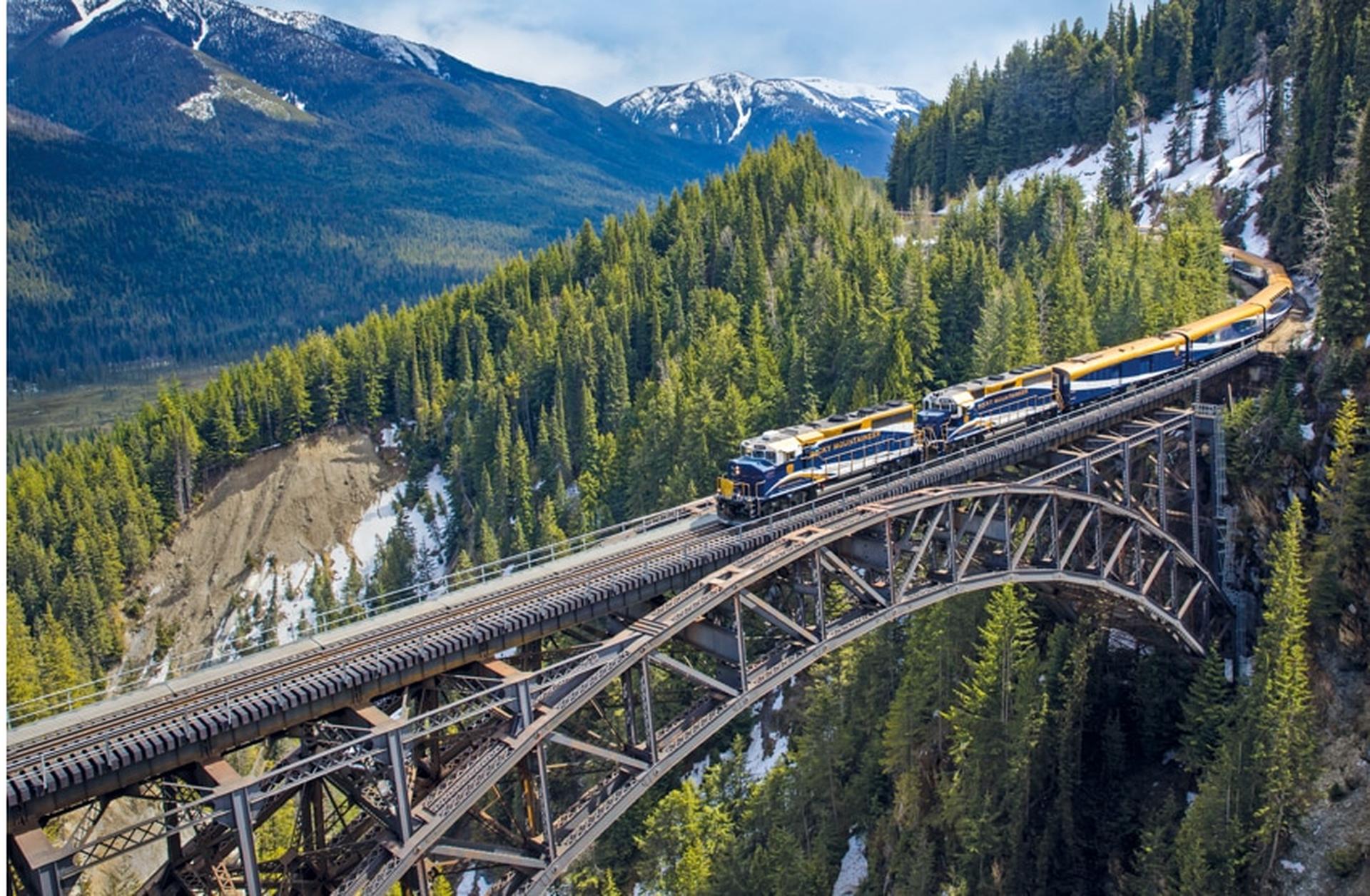 Rocky Mountaineer train crosses a bridge in the mountains