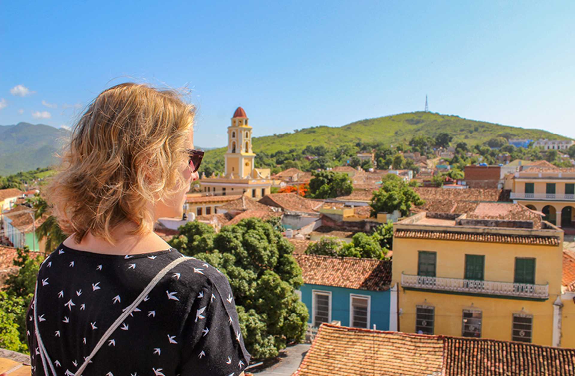 A woman looks out over the historic city of Trinidad in Cuba
