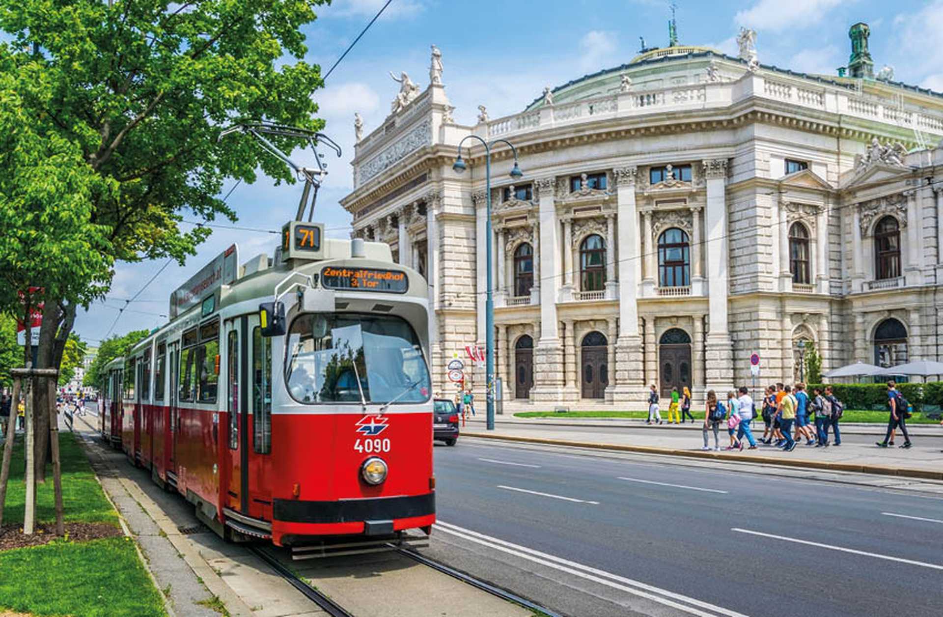 Red tram outside the Imperial Court theatre on the Ringstrasse, Vienna, Austria