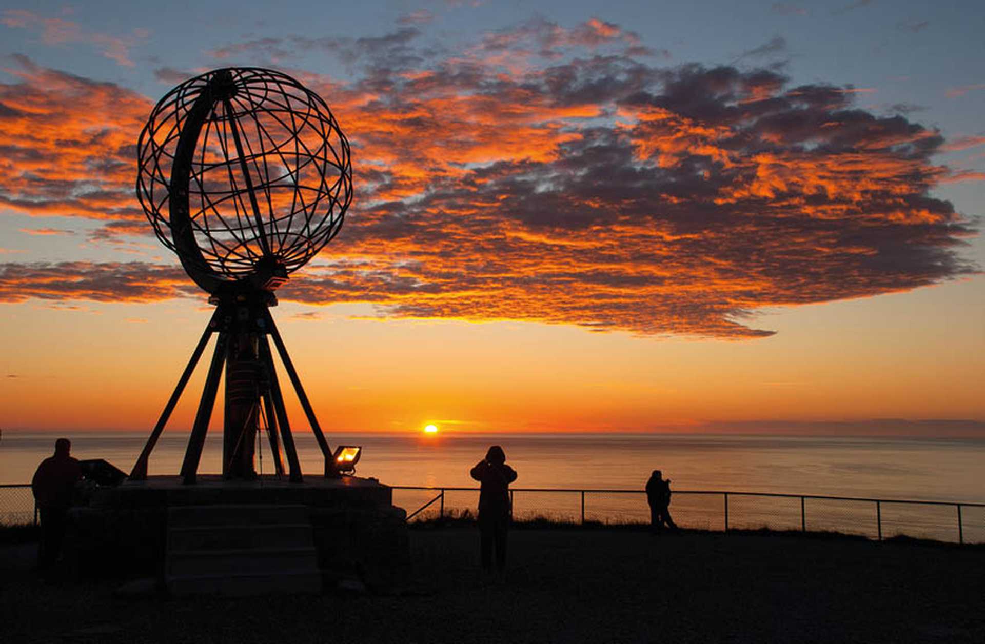 Midnight Sun behind the Globe Monument at North Cape, Norway