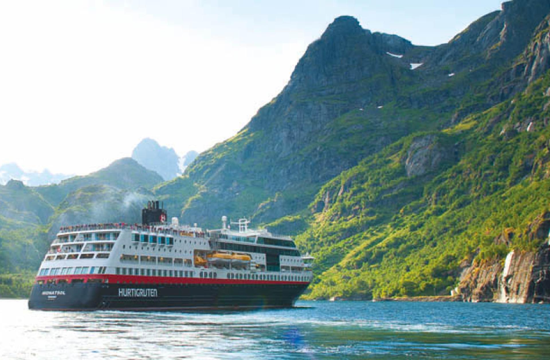 Hurtigruten's Midnasol cruise ship sails into a Norwegian fjord