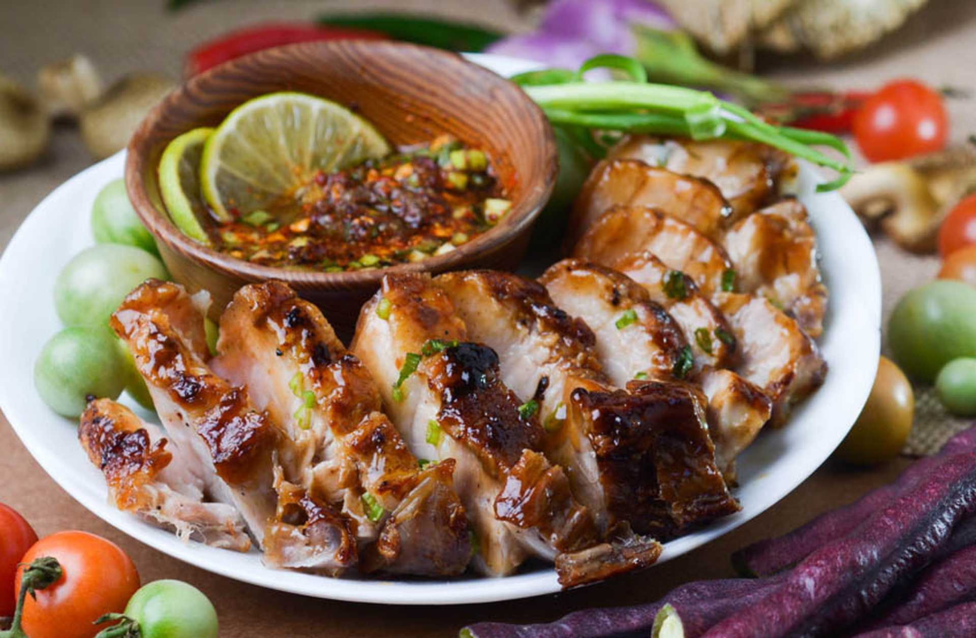 Close-up of a Thai fish dish served with slices of lime