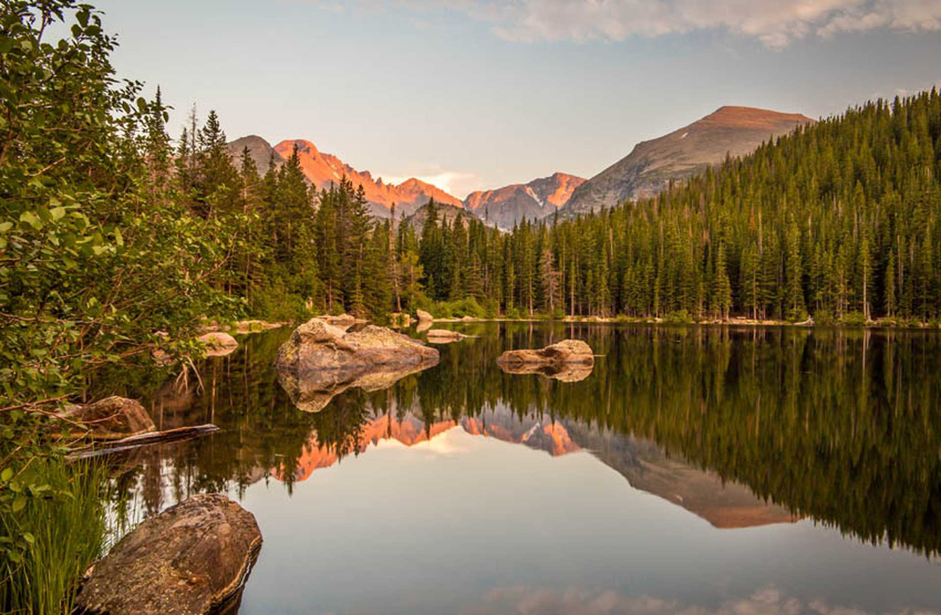 Sunset reflection of mountains and rocks at Bear Lake in Rocky Mountain National Park, Colorado