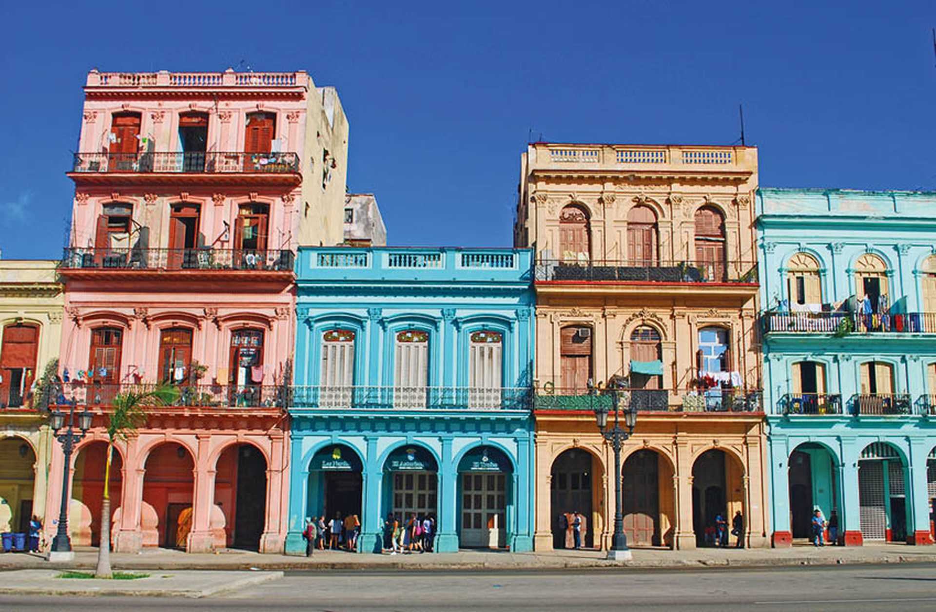 Colourful colonial-style buildings line a street in Havana, where we begin our Cuba tours