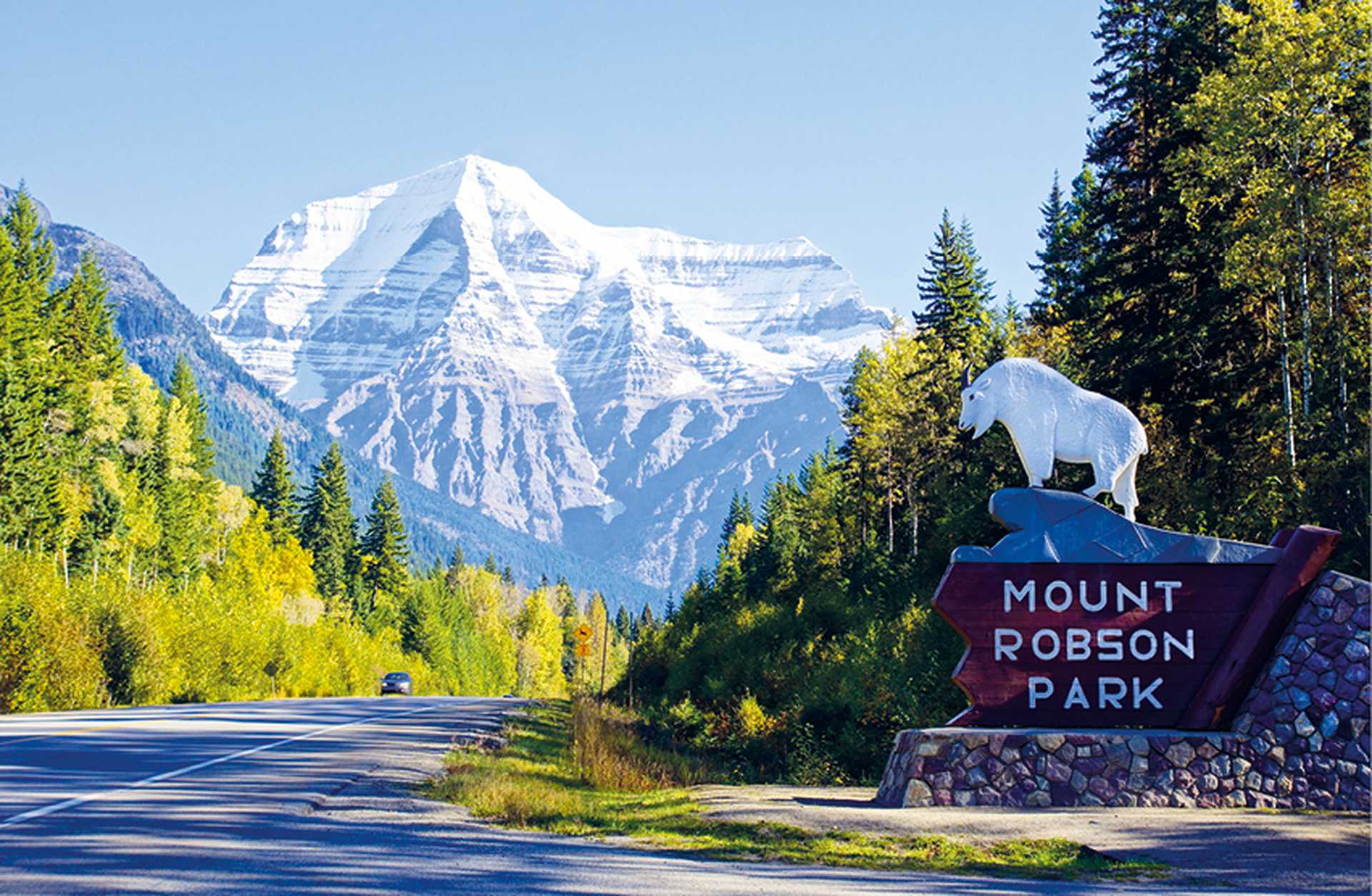 Entrance to Mount Robson Park in the Canadian Rockies, with snow-covered mountains and forests in the background