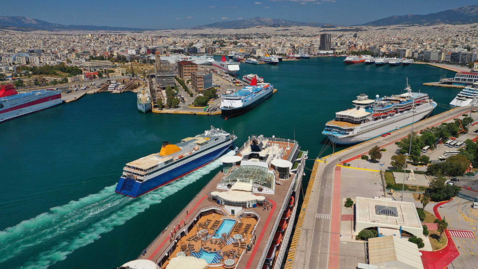 Aerial drone photo of passenger ferry reaching destination - busy port of Piraeus, Attica, Greece