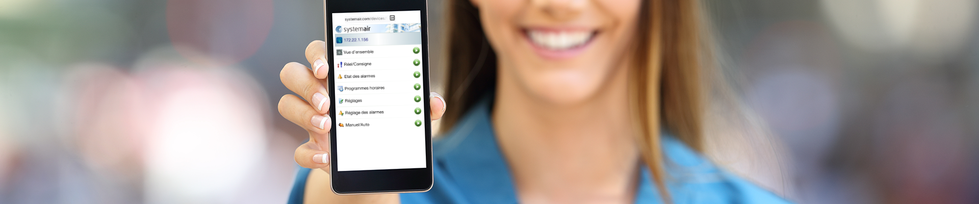 Femme souriante montrant un écran de portable ouvert sur l'application