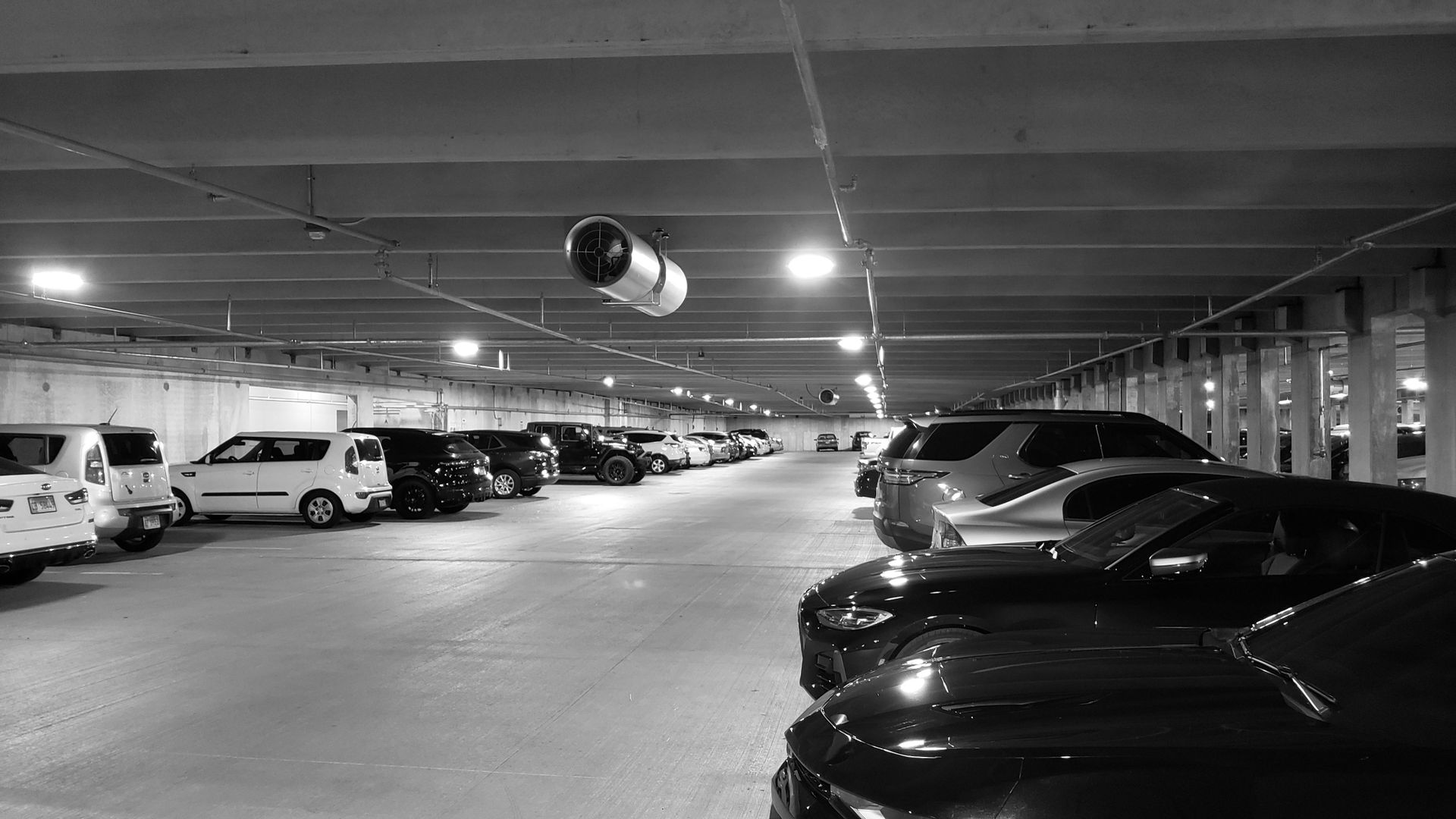 Black and white photo of a parking garage