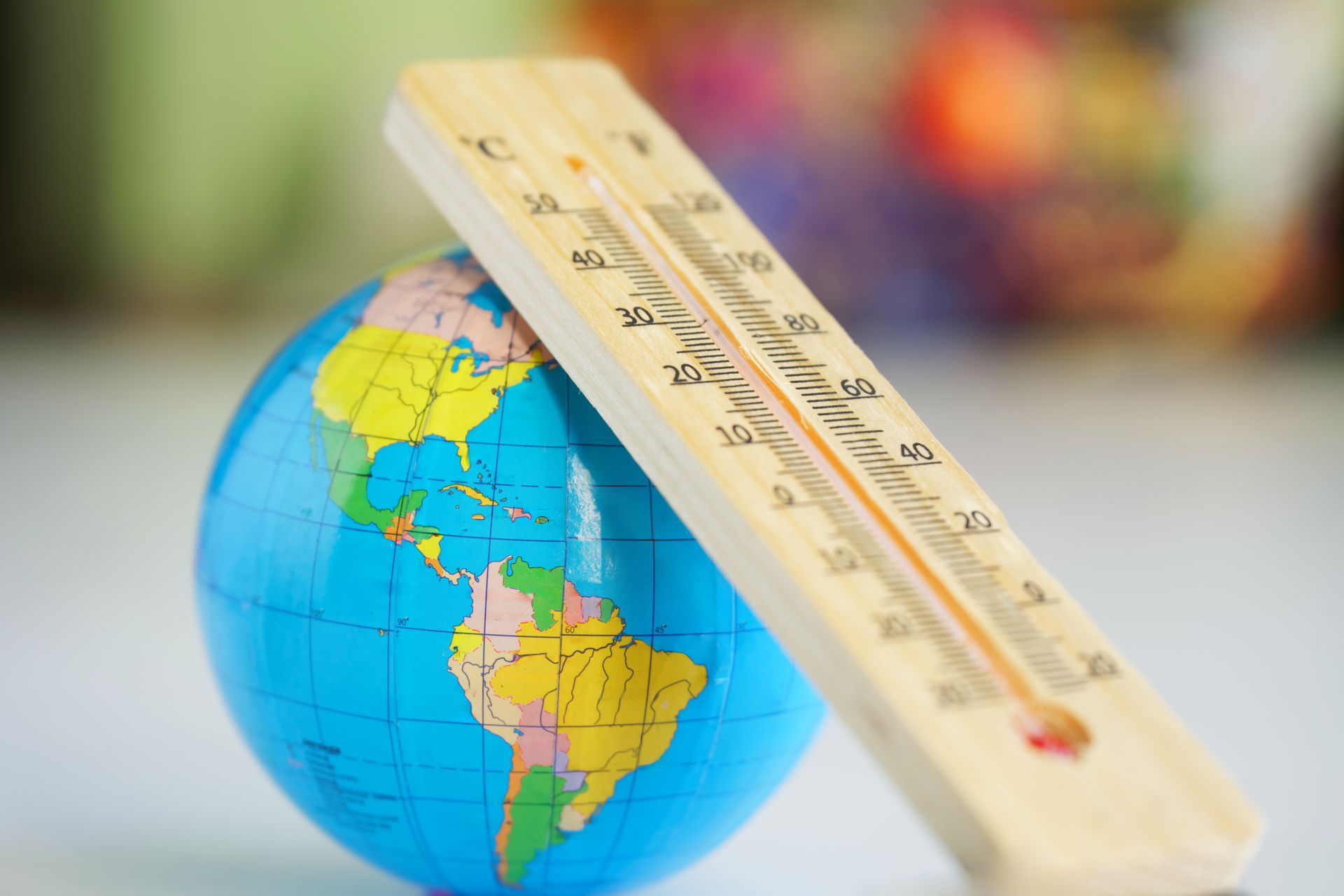 A weather thermometer on a small globe
