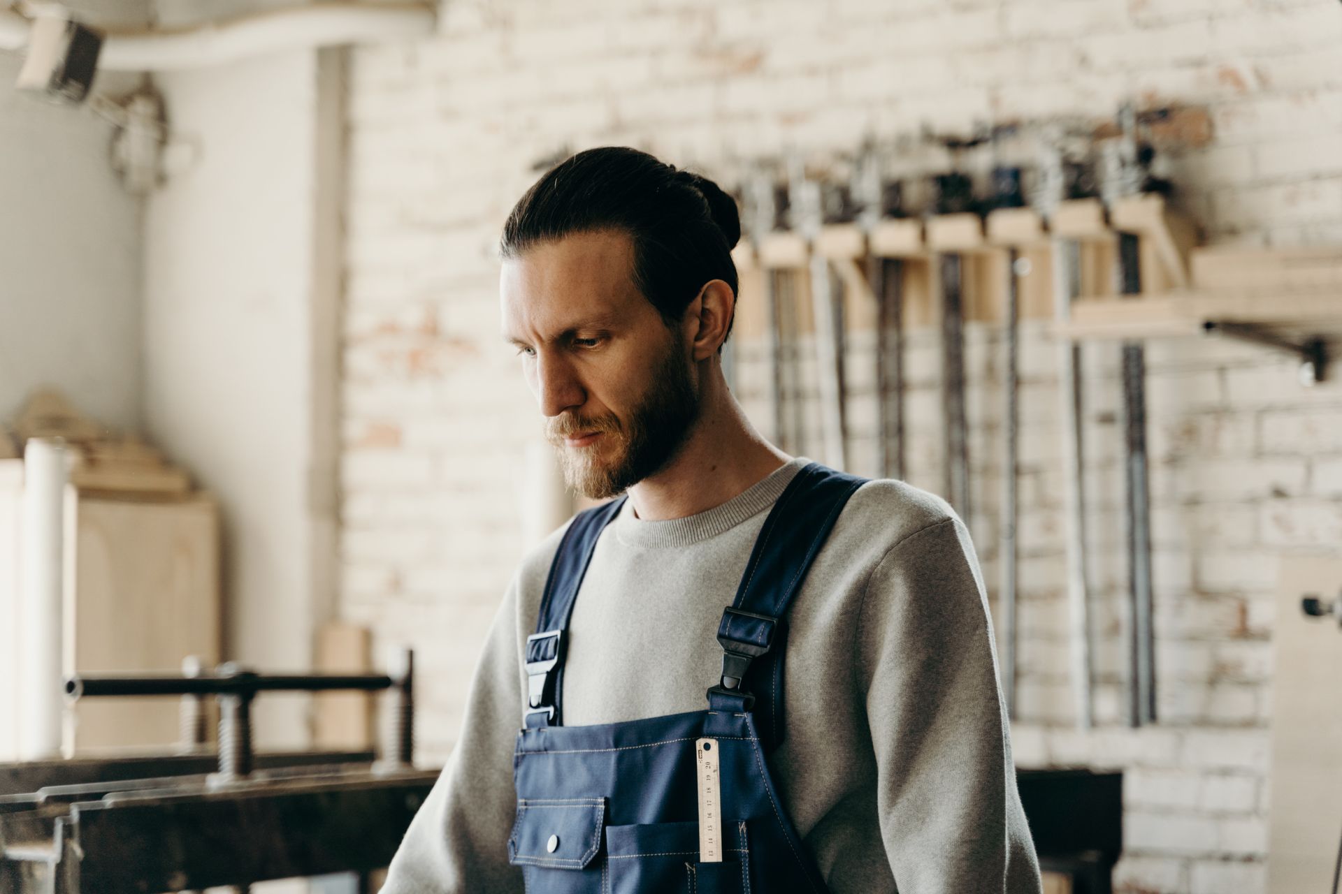 Man wearing overalls in a workshop