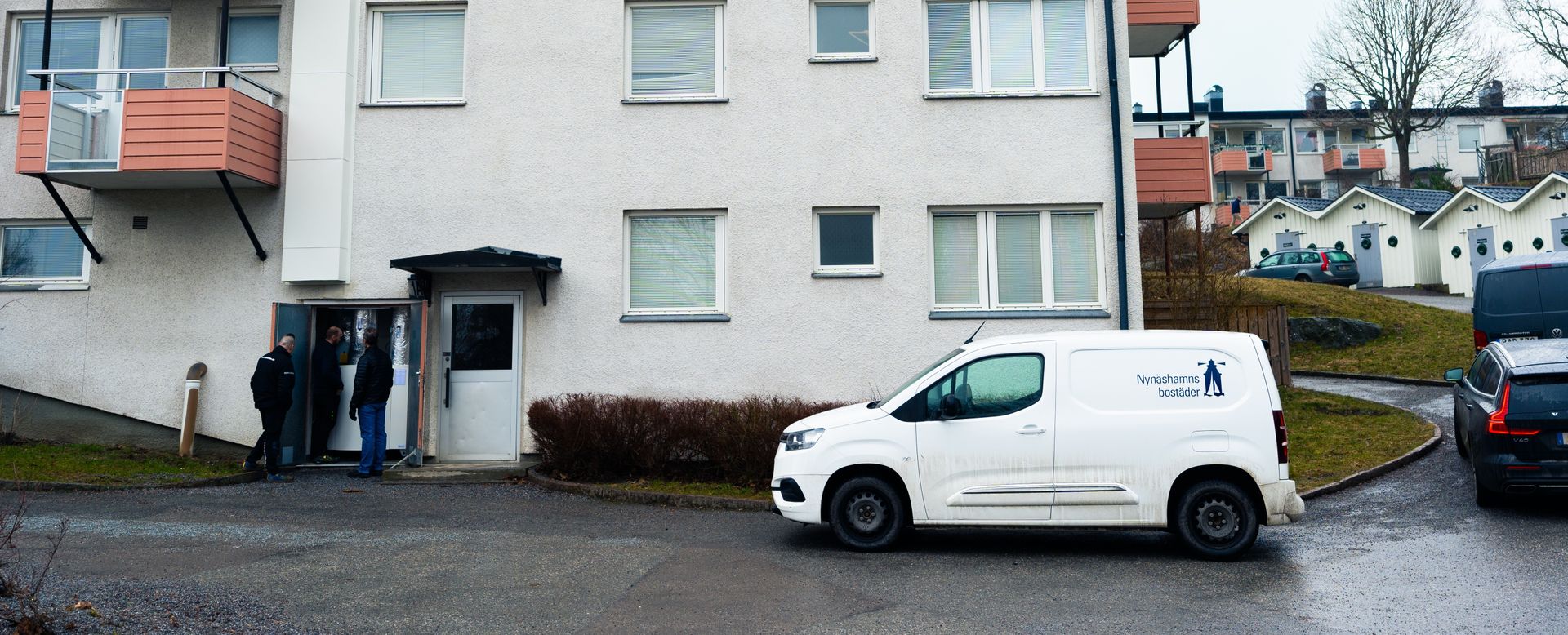 Photograph of a branded van next to a apartment building