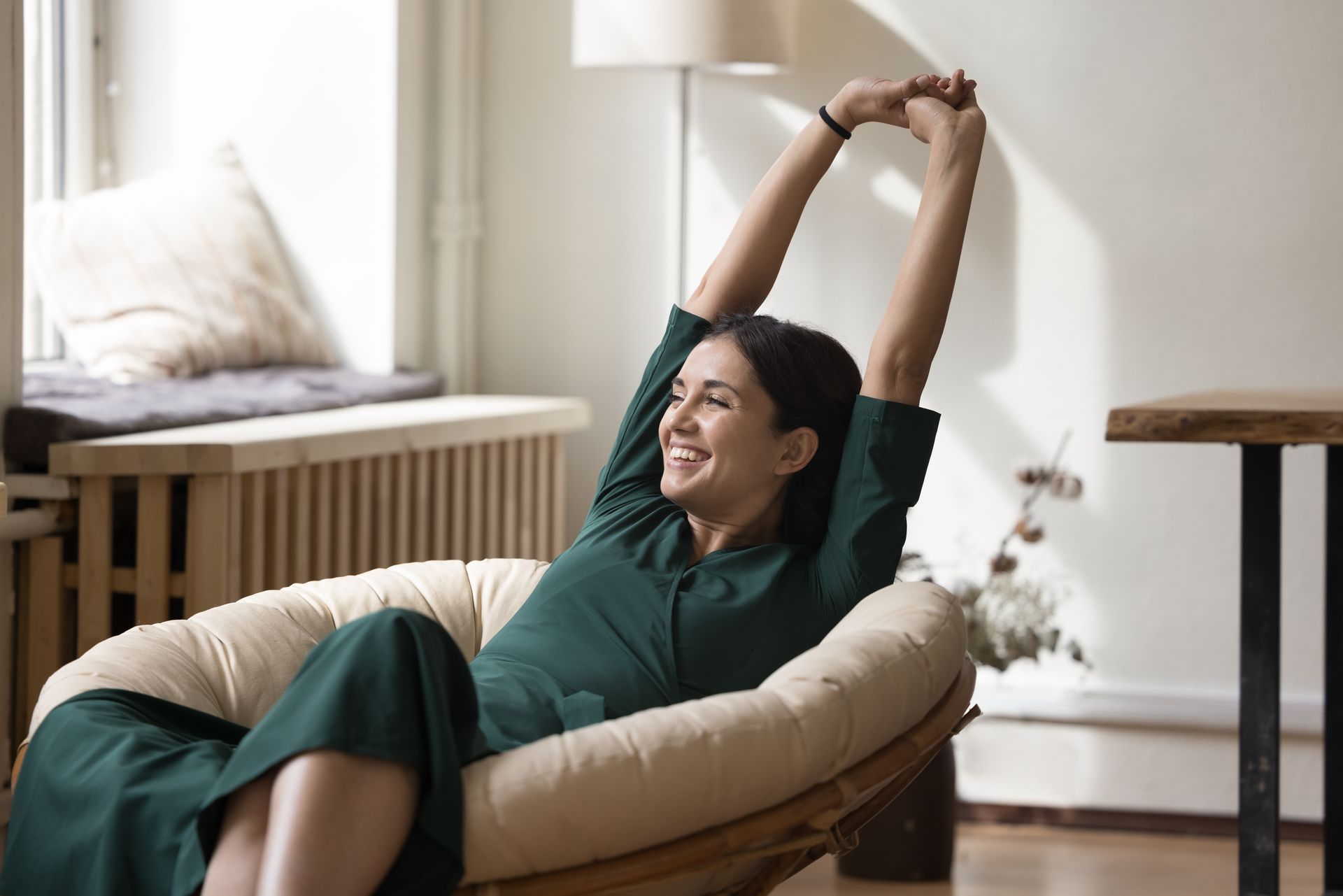 Stock Photograph of a woman stretching in a chair
