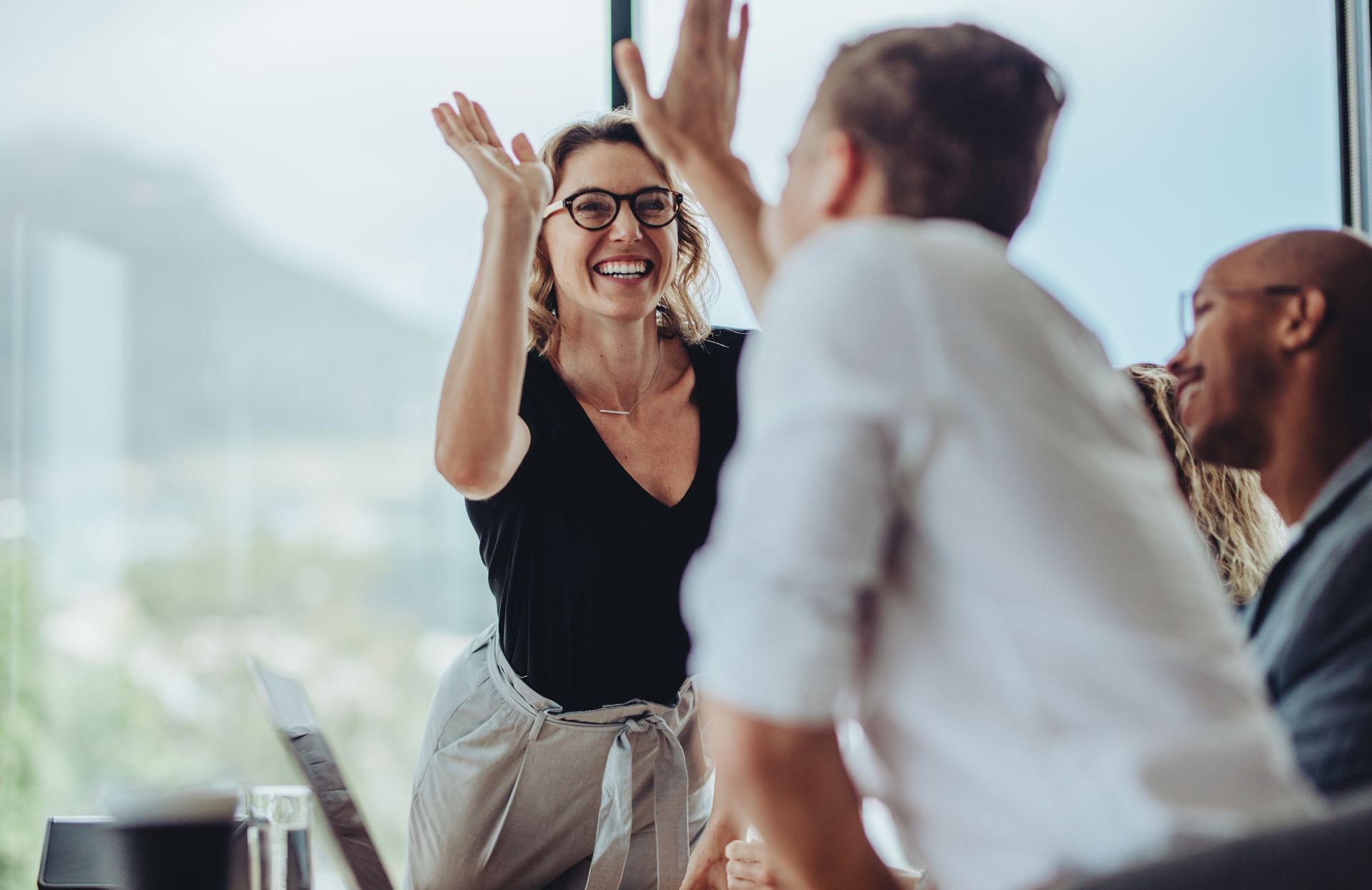 Stock photograph of two people doing a high five
