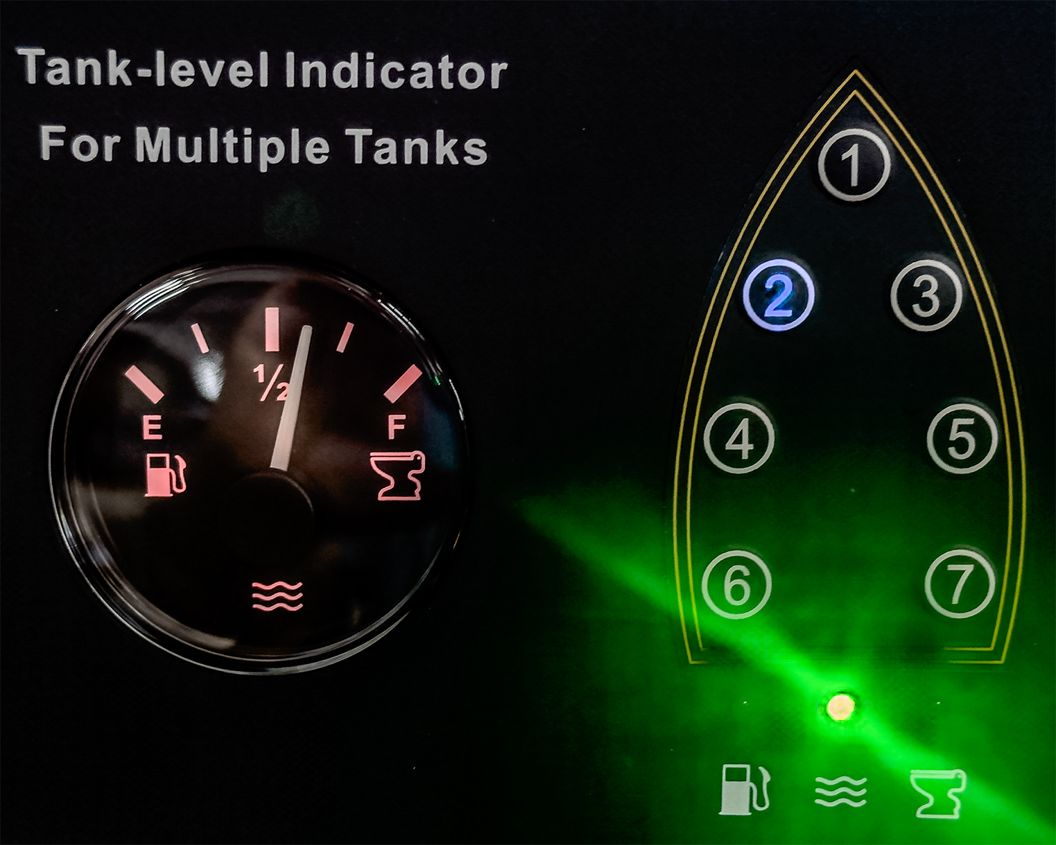 Tank-level indicator panel with a fuel gauge on the left and numbered buttons 1-7 on the right, illuminated by a green light.
