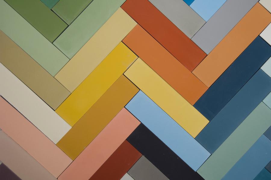 A colorful herringbone pattern made of rectangular tiles in various...