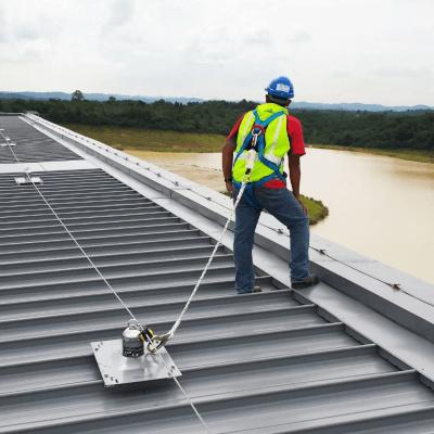 Man with safety harness looking over the edge