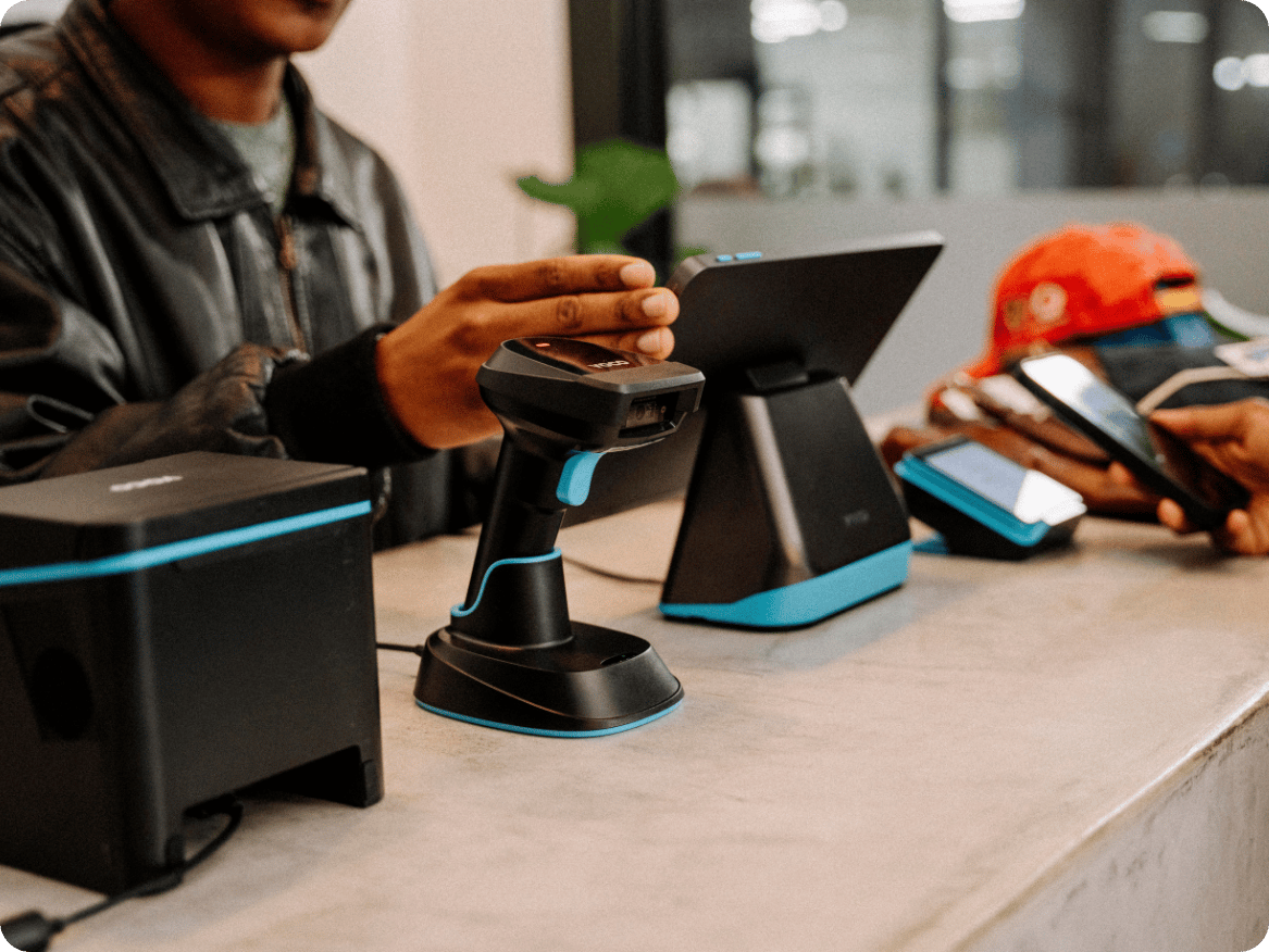 Retailer taking a payment at a point of sale counter