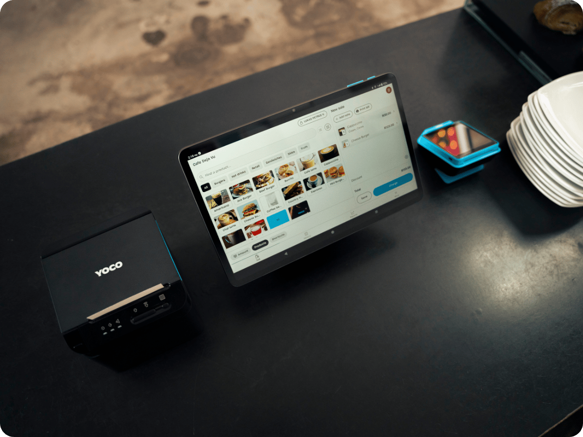 Point of sale screen and receipt printer on a restaurant counter